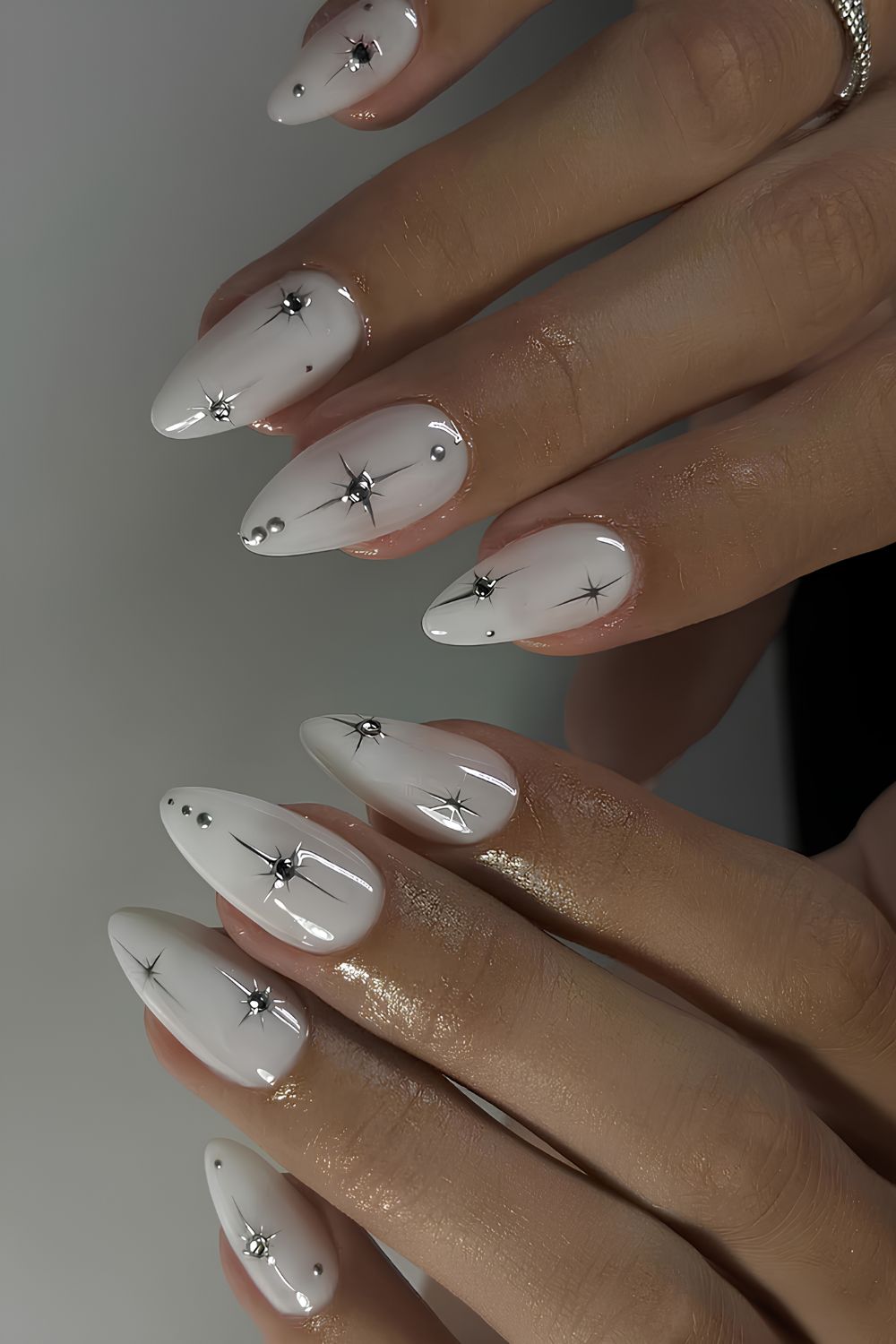 White nails with silver stars and gems