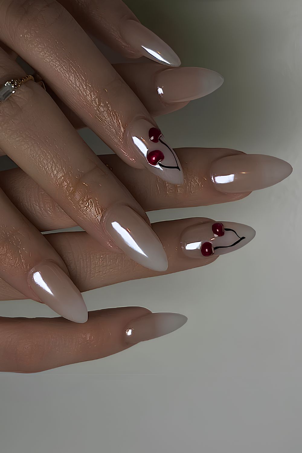 White ombre chrome mani with cherry accents