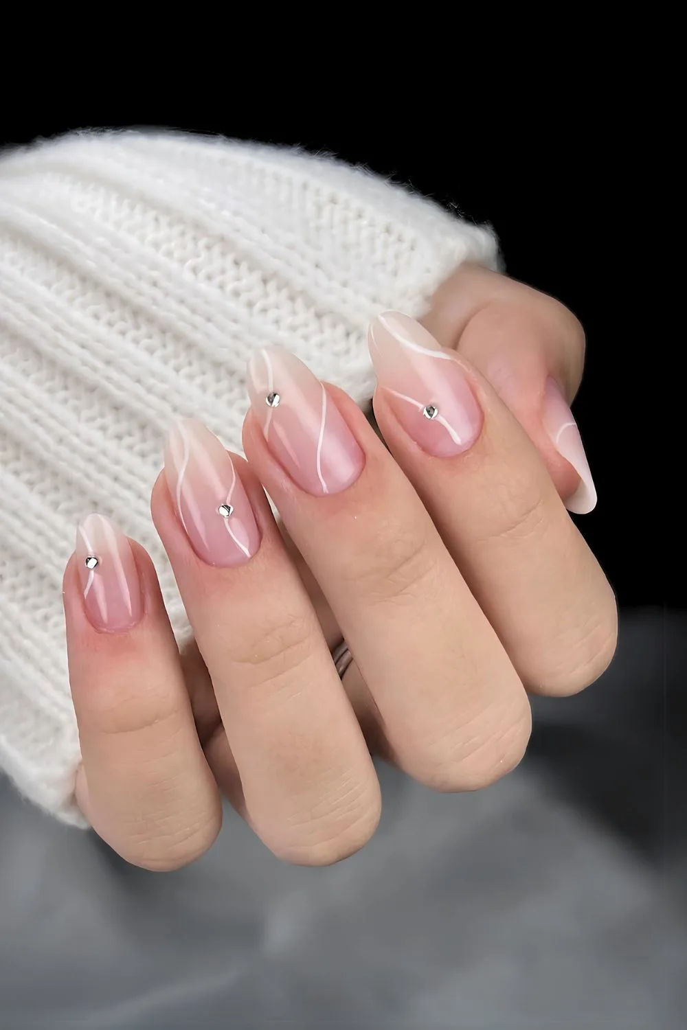 White ombre nails with swirls and rhinestones