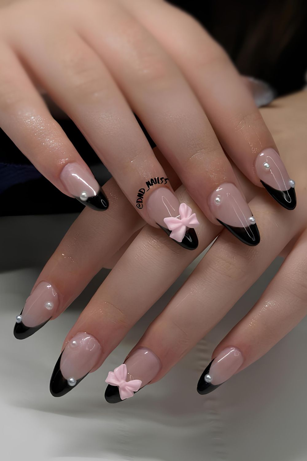 Black French mani with pearls and pink bows