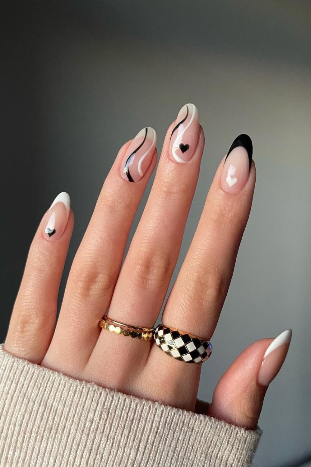 Black and white French tip nails with swirls and hearts