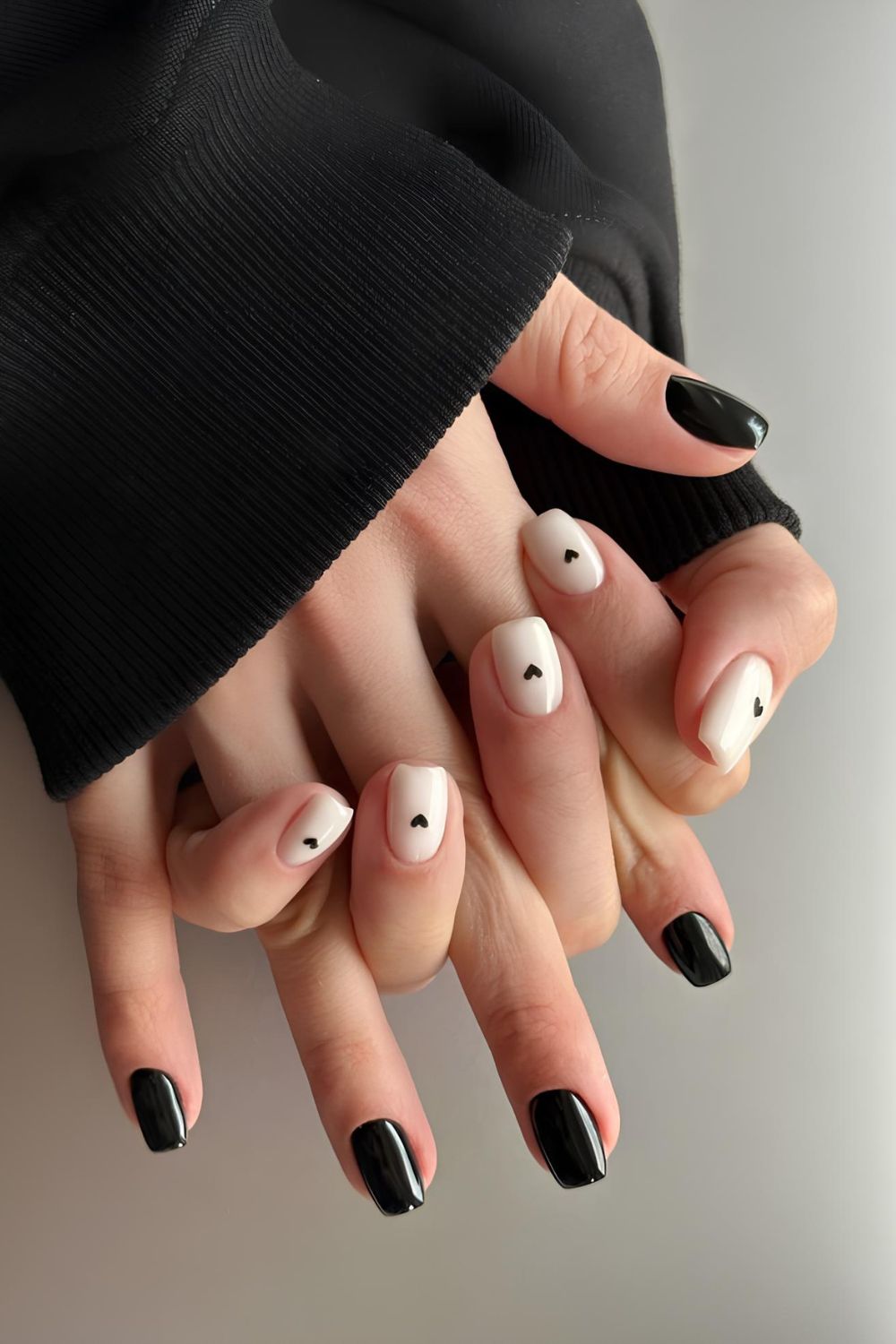 Black and white nails with tiny heart accents