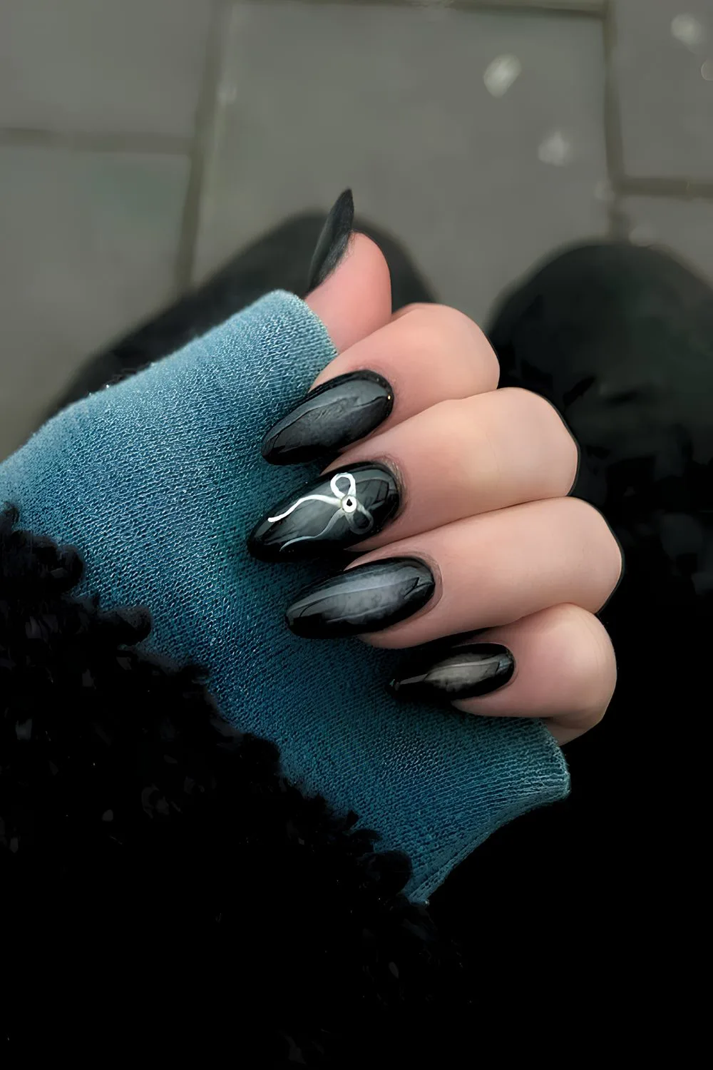 Black aura nails with silver bow accent