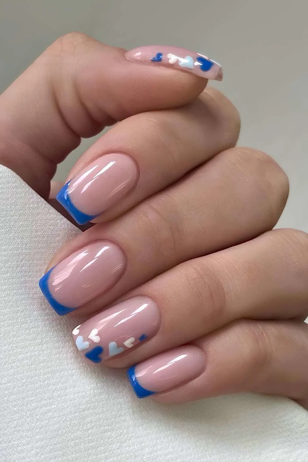 Blue French manicure with micro hearts