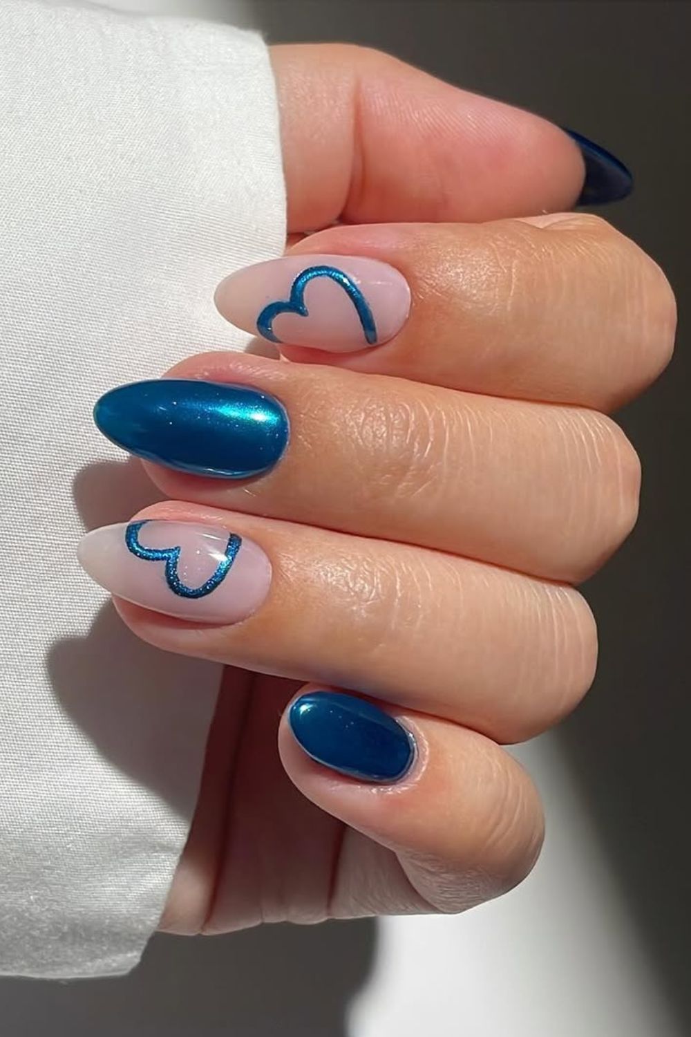 Blue chrome nails with heart accents