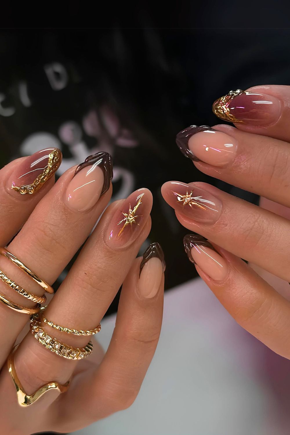 Brown aura nails with gold chrome accents