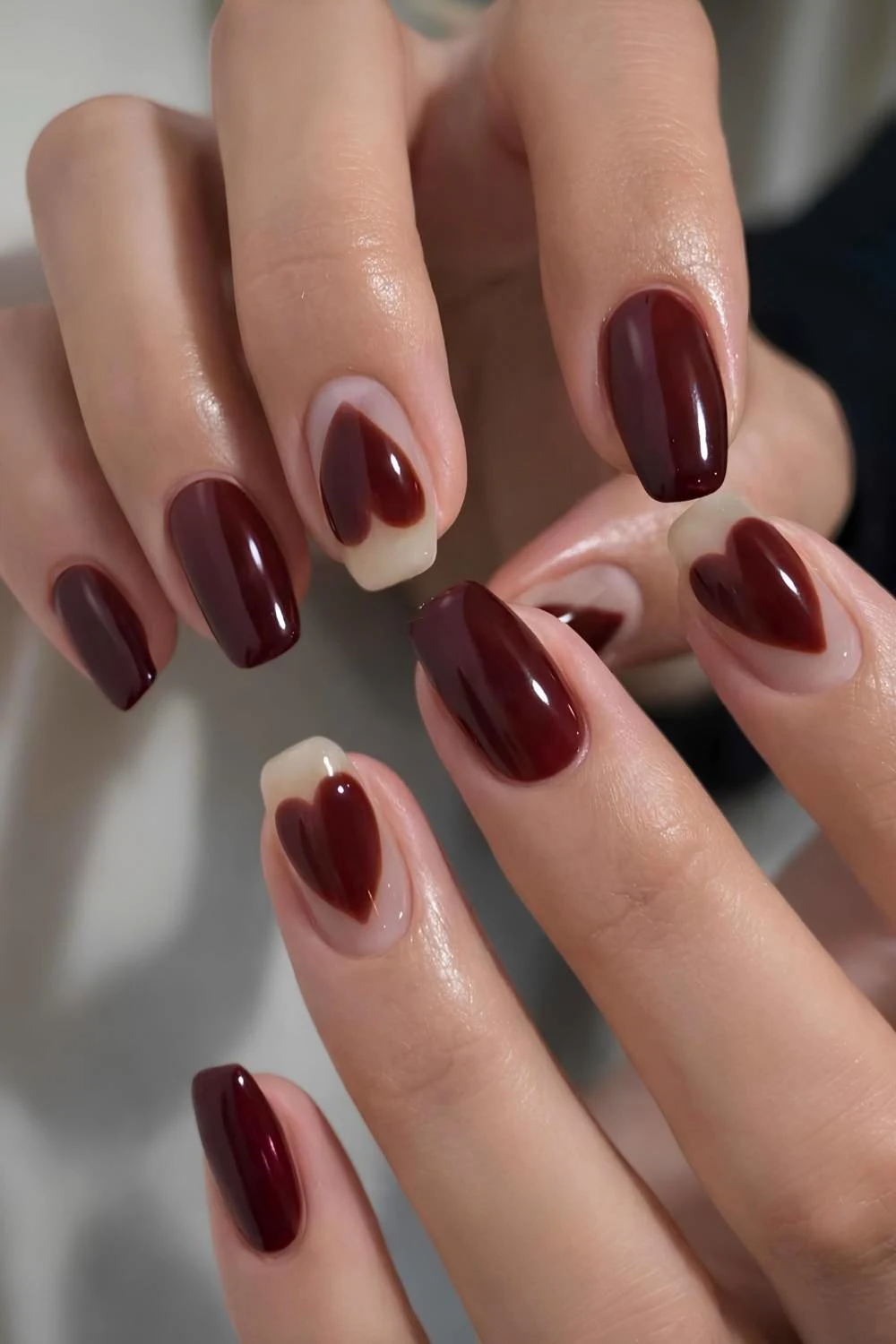 Burgundy nails with oversize heart art
