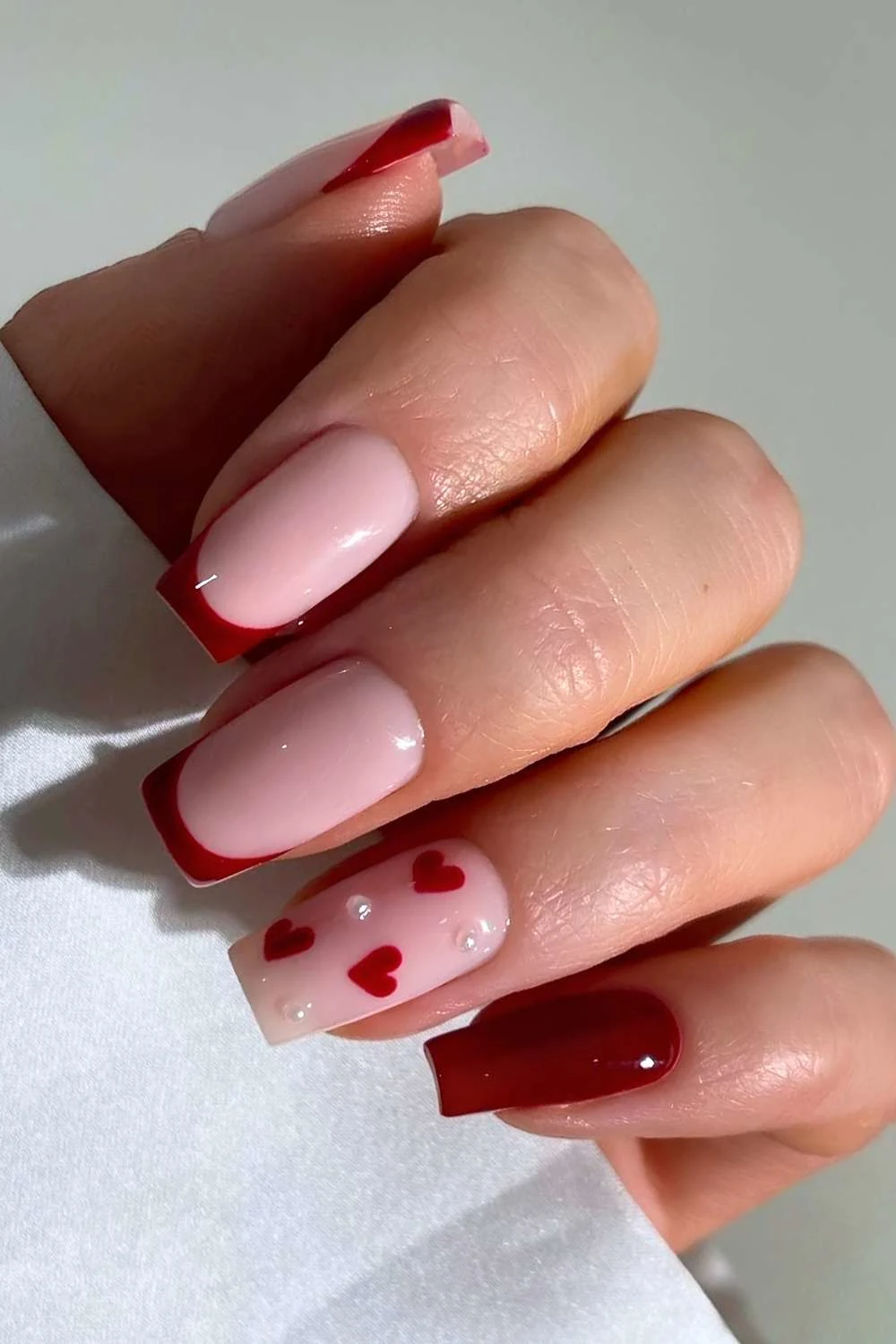 Burgundy nails with pearls and hearts