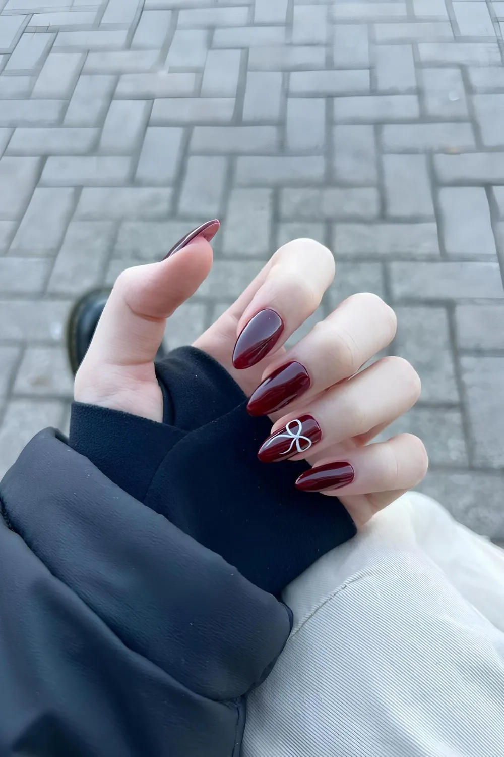 Burgundy nails with white bow accent