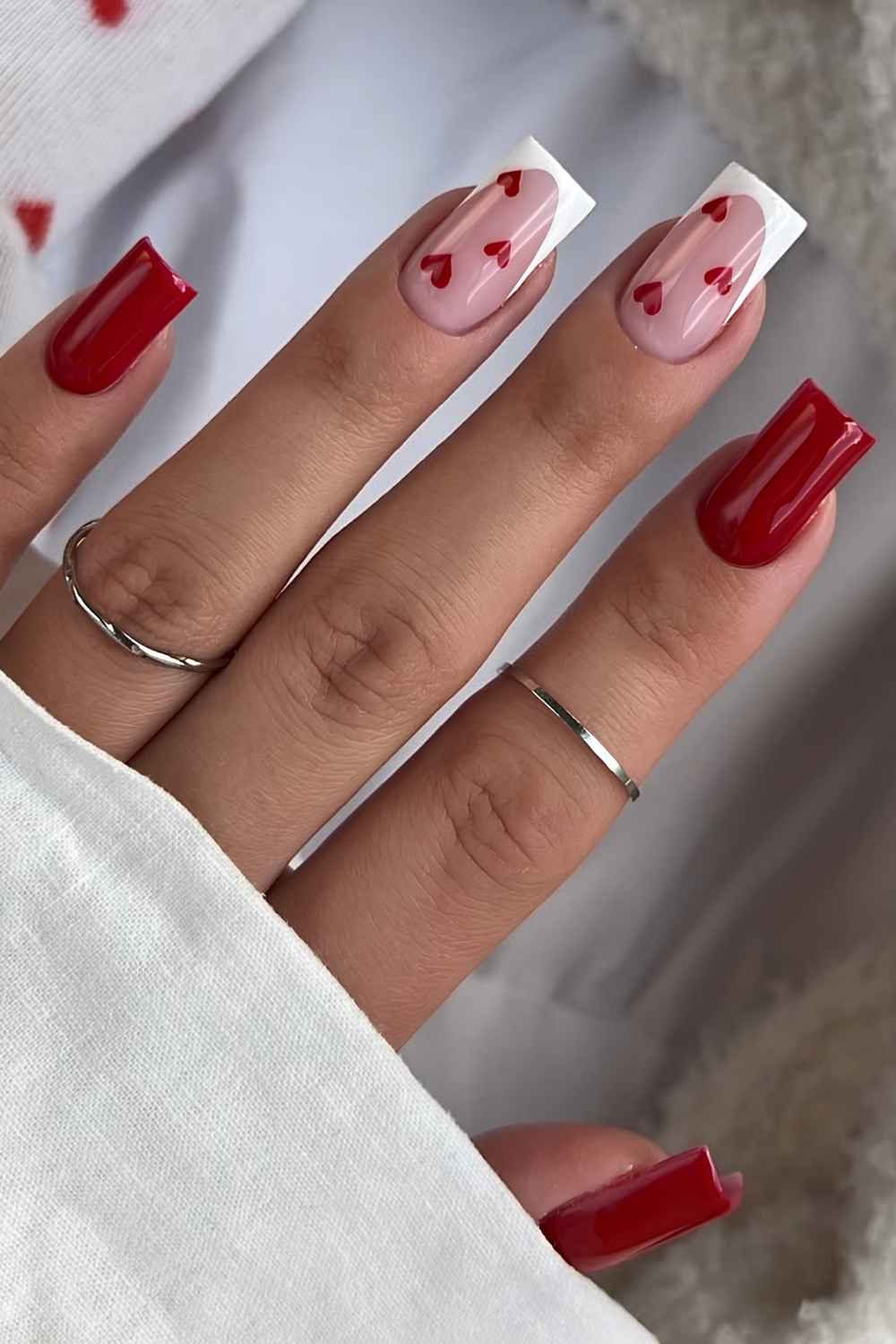 Cherry red and white nails with accent hearts