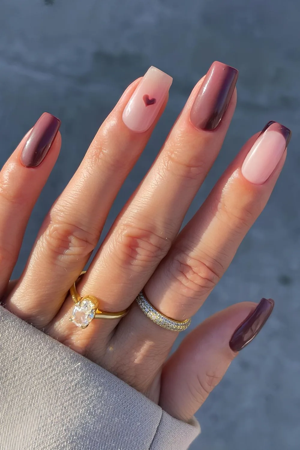 Chocolate brown nails with heart accent in the same hue