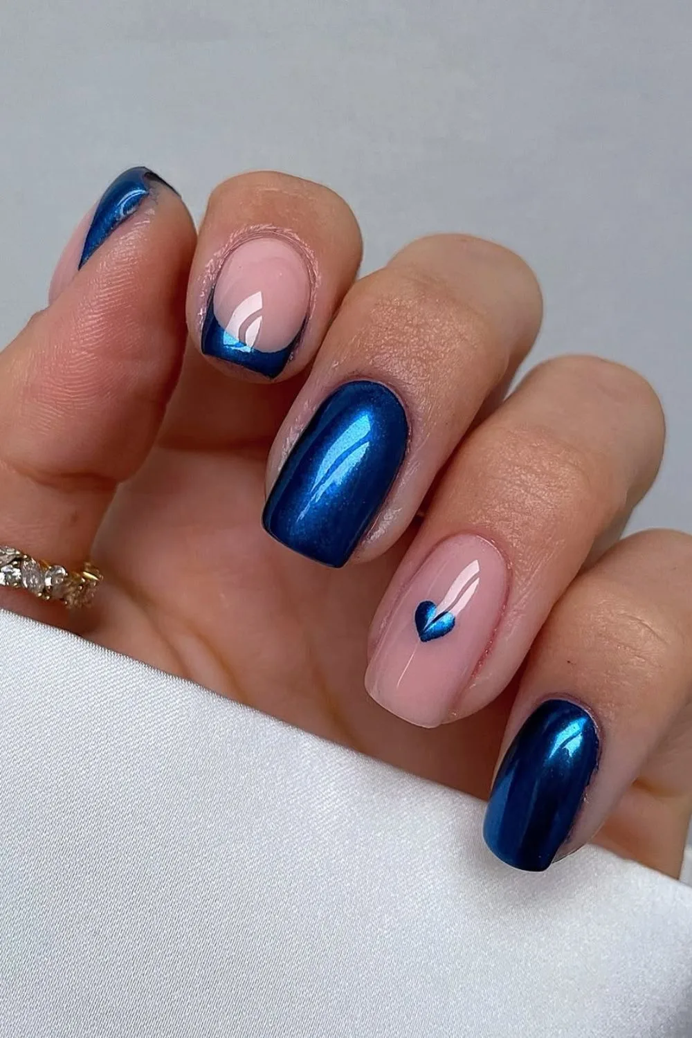 Cobalt blue nails with heart accent in the same shade