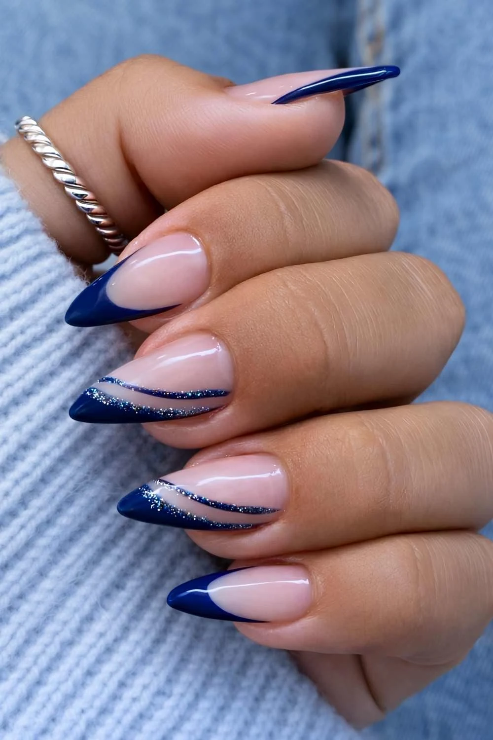 Dark blue French mani with glitter swirls