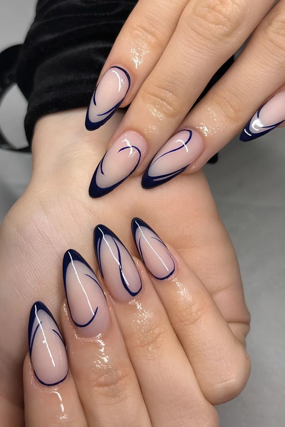 Dark blue French tip nails with swirls