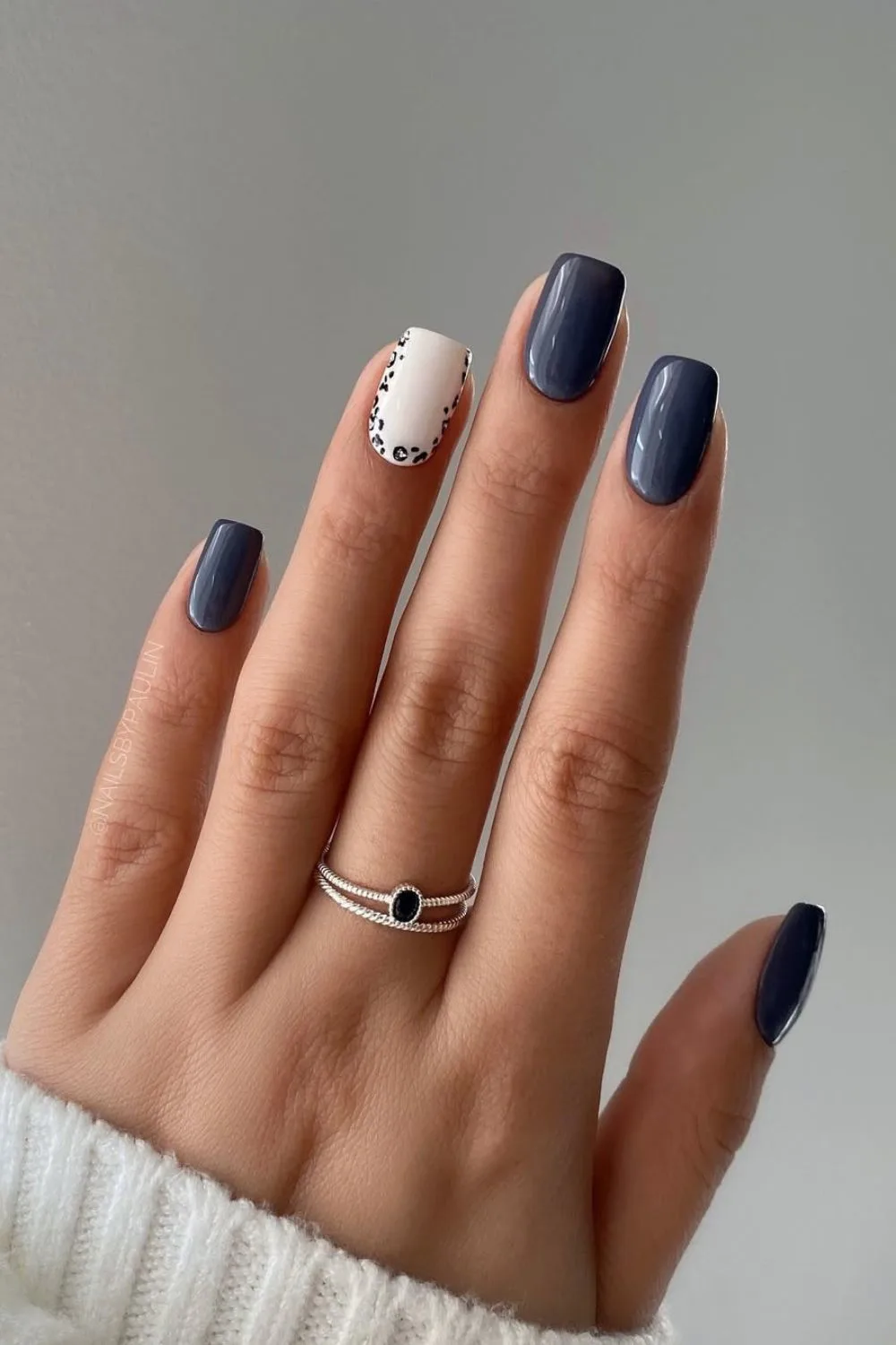 Dark blue nails with white and animal print accent