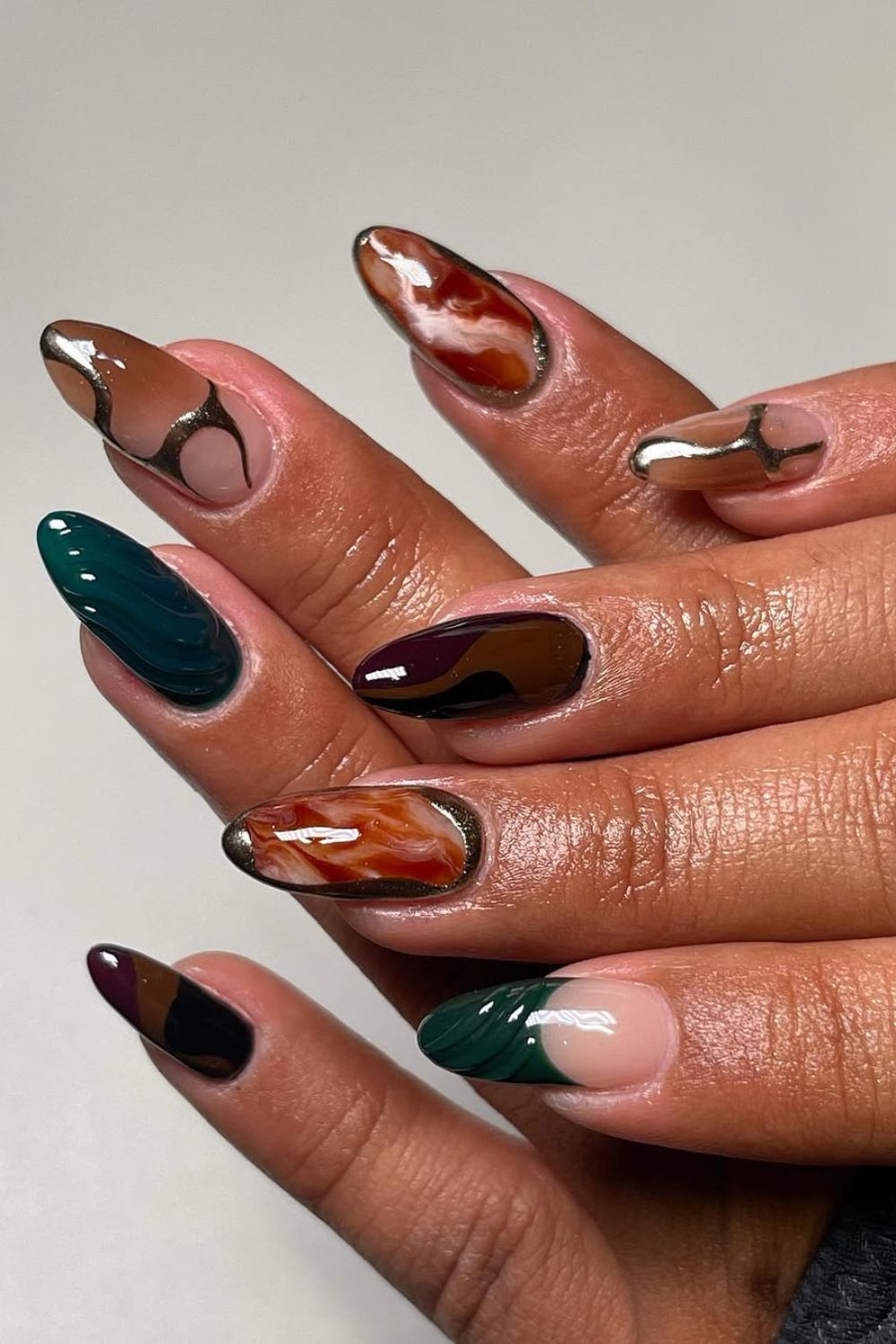 Dark mix and match nails with chrome accents