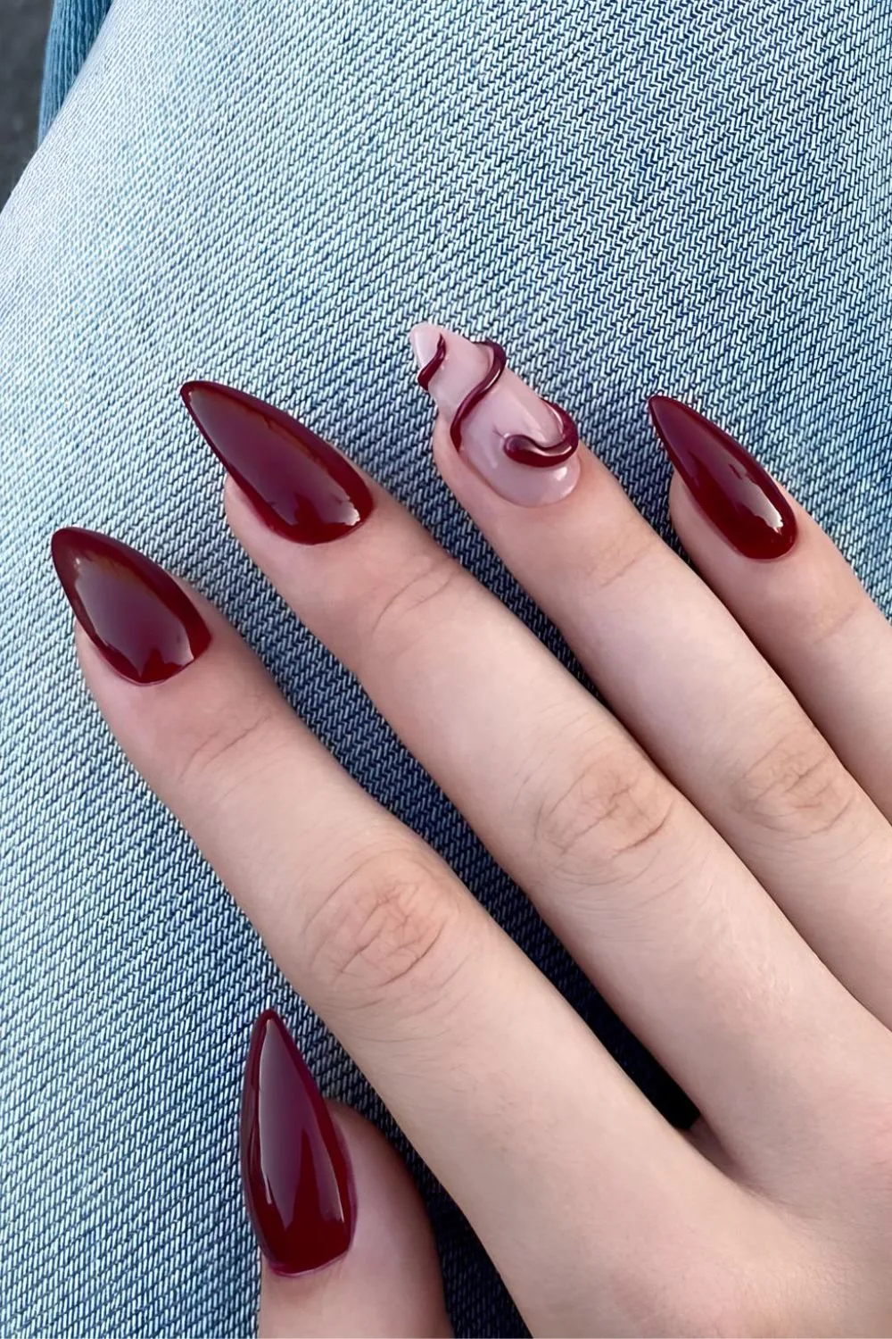 Dark red nails with 3d snake accent