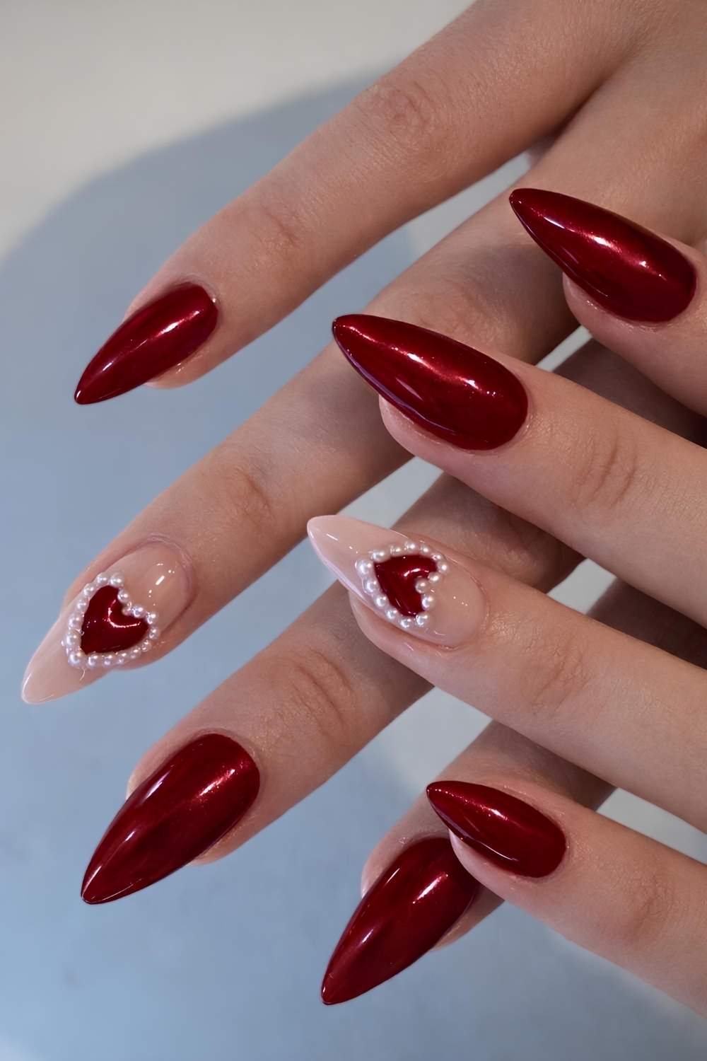 Dark red nails with pearl hearts