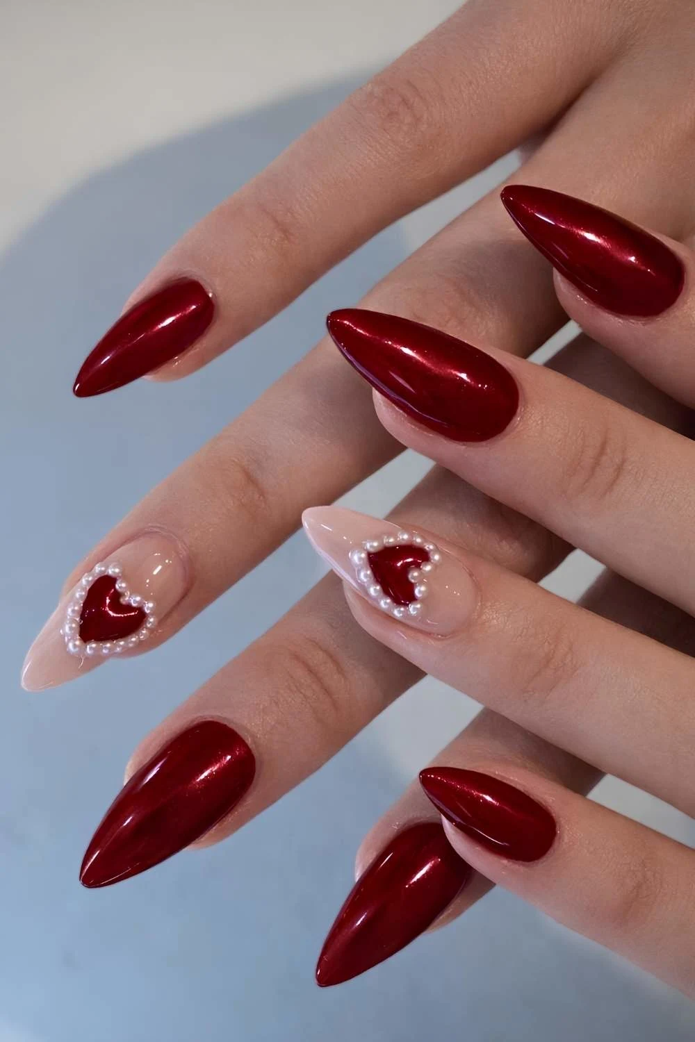Dark red nails with pearl hearts