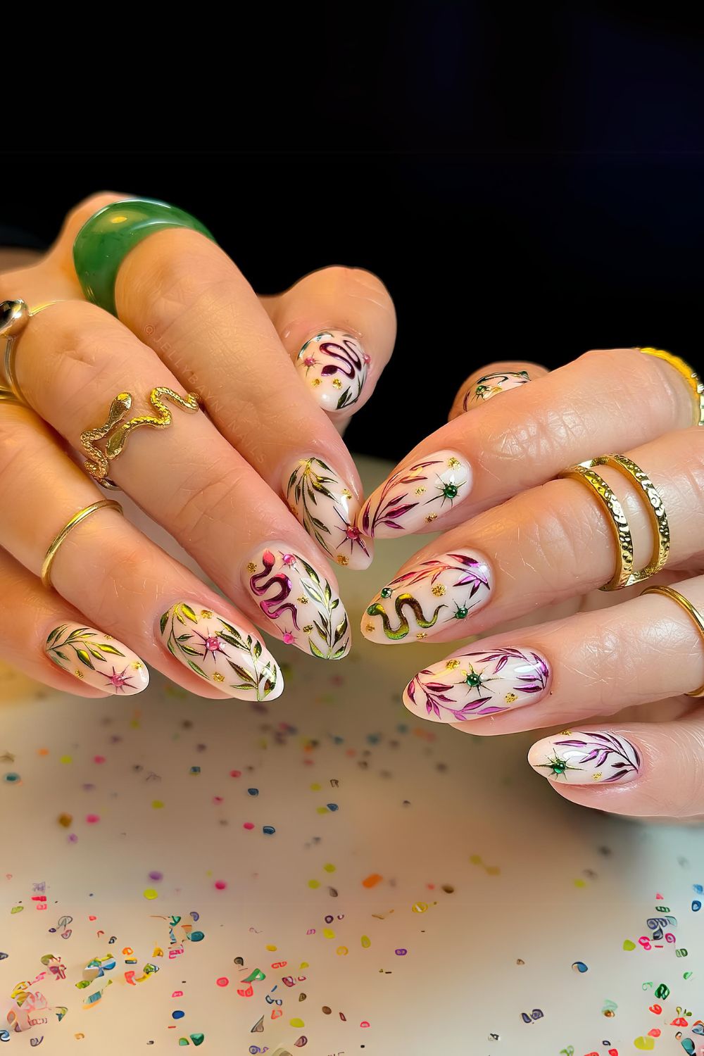 Floral themed nails with snake design