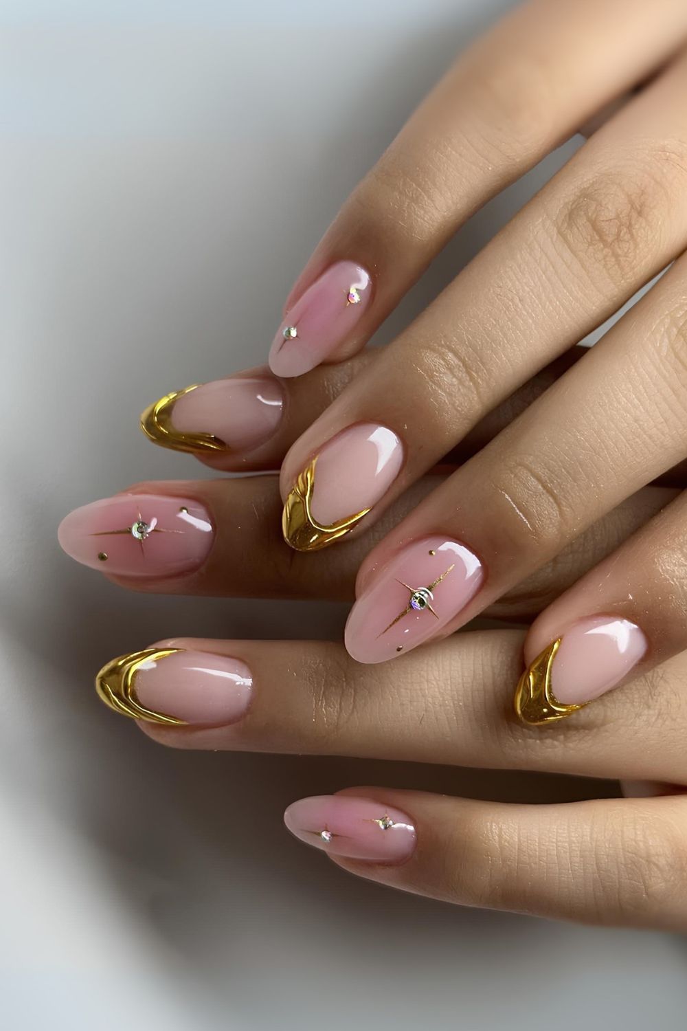 Gold French nails with pink aura accents