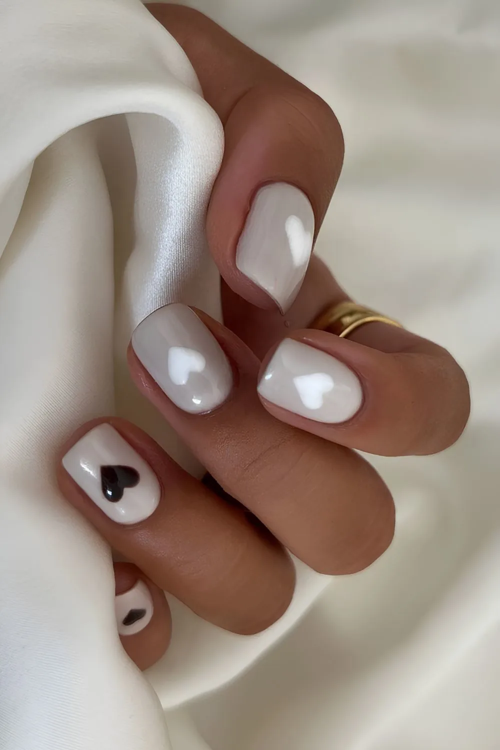 Gray nails with black and white hearts