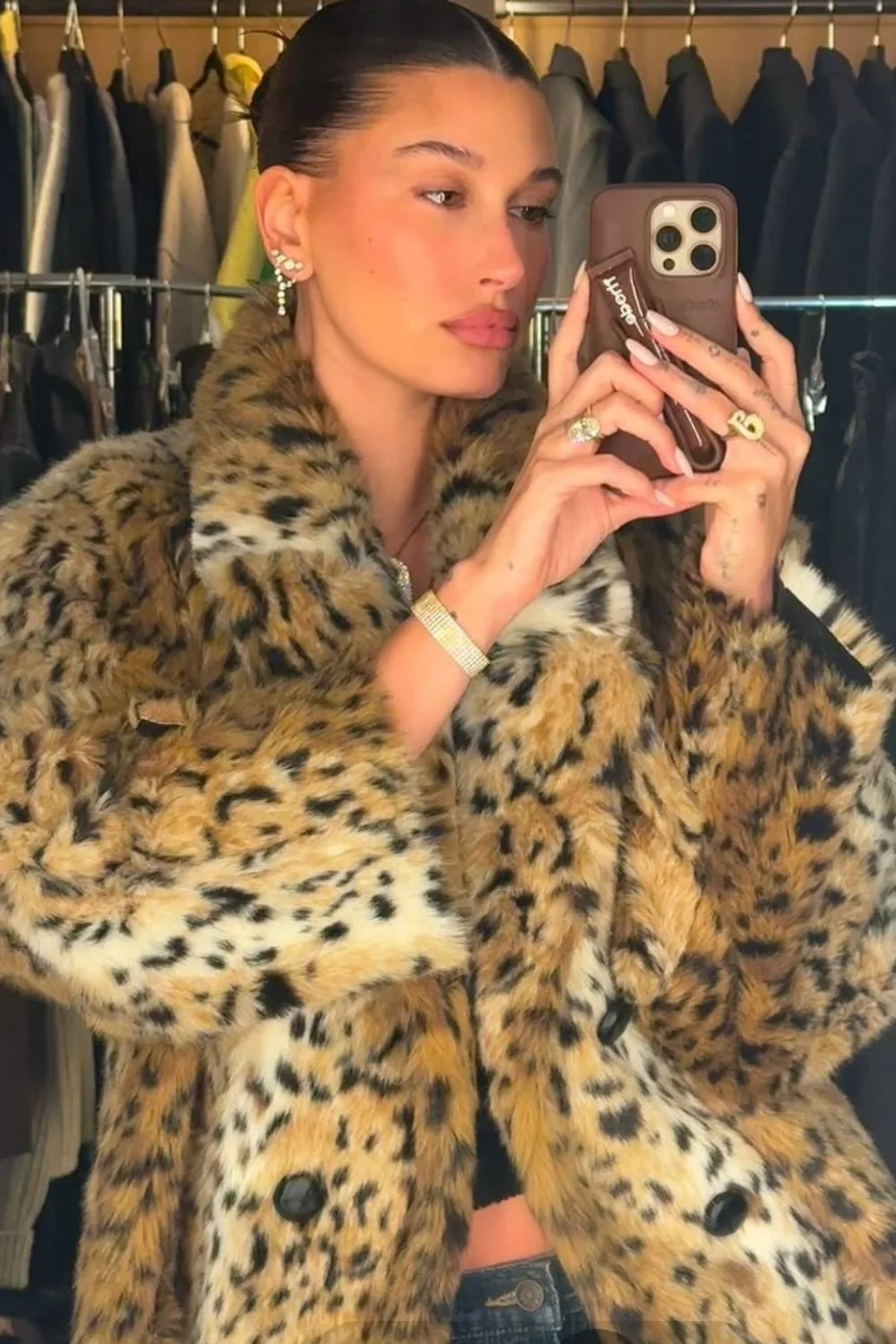 Hailey Bieber wearing a milky manicure and taking a picture