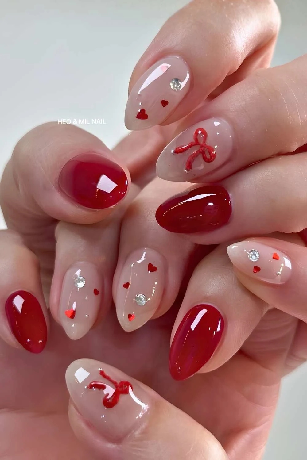 Jelly red nails with bows and hearts