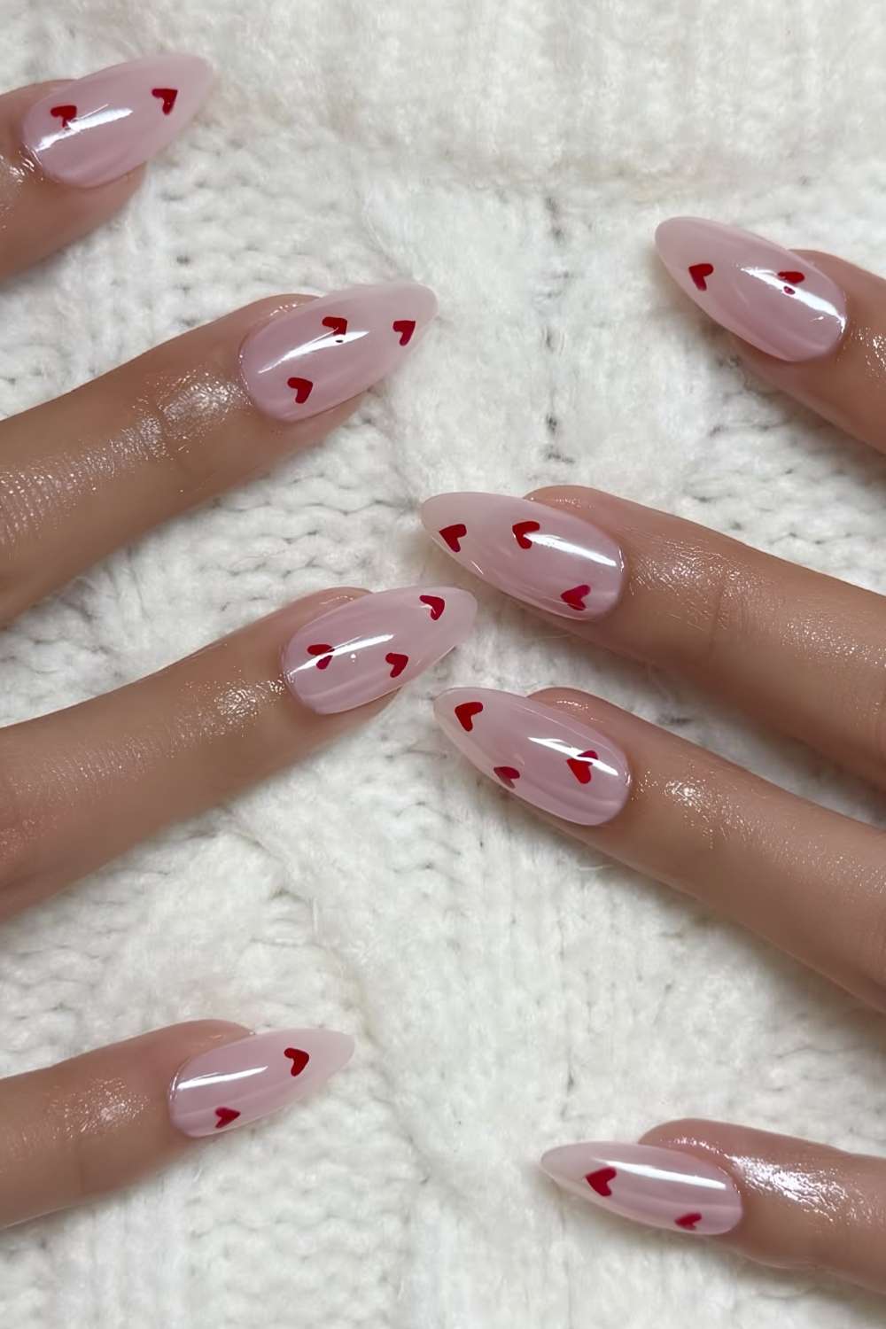 Light pink chrome manicure with red hearts