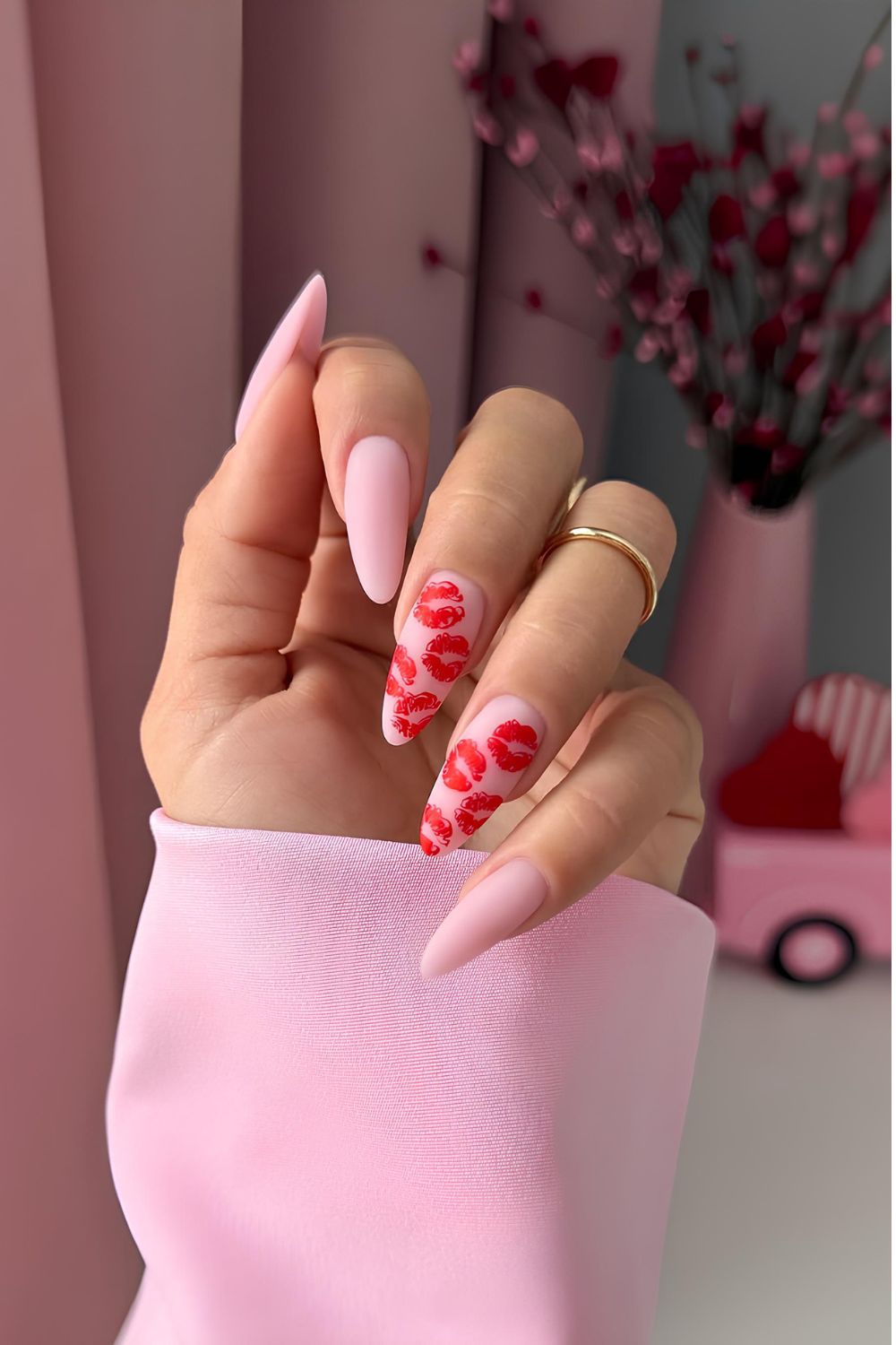 Matte pink nails with red kiss accents