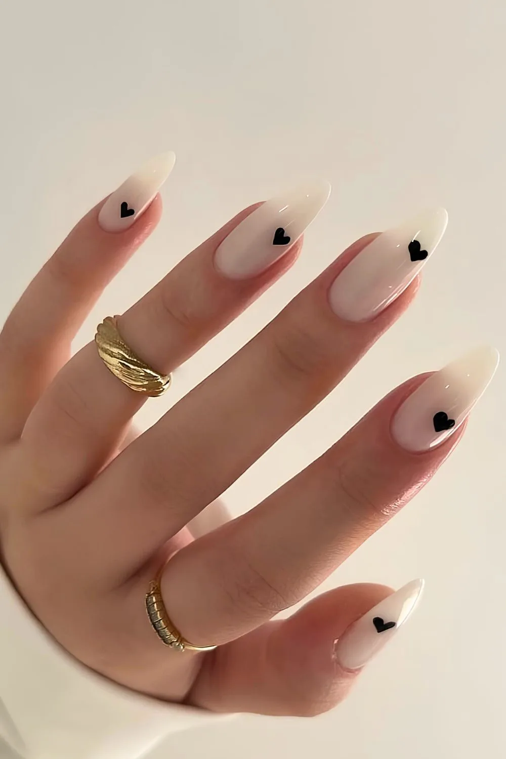 Milky white nails with black heart accents