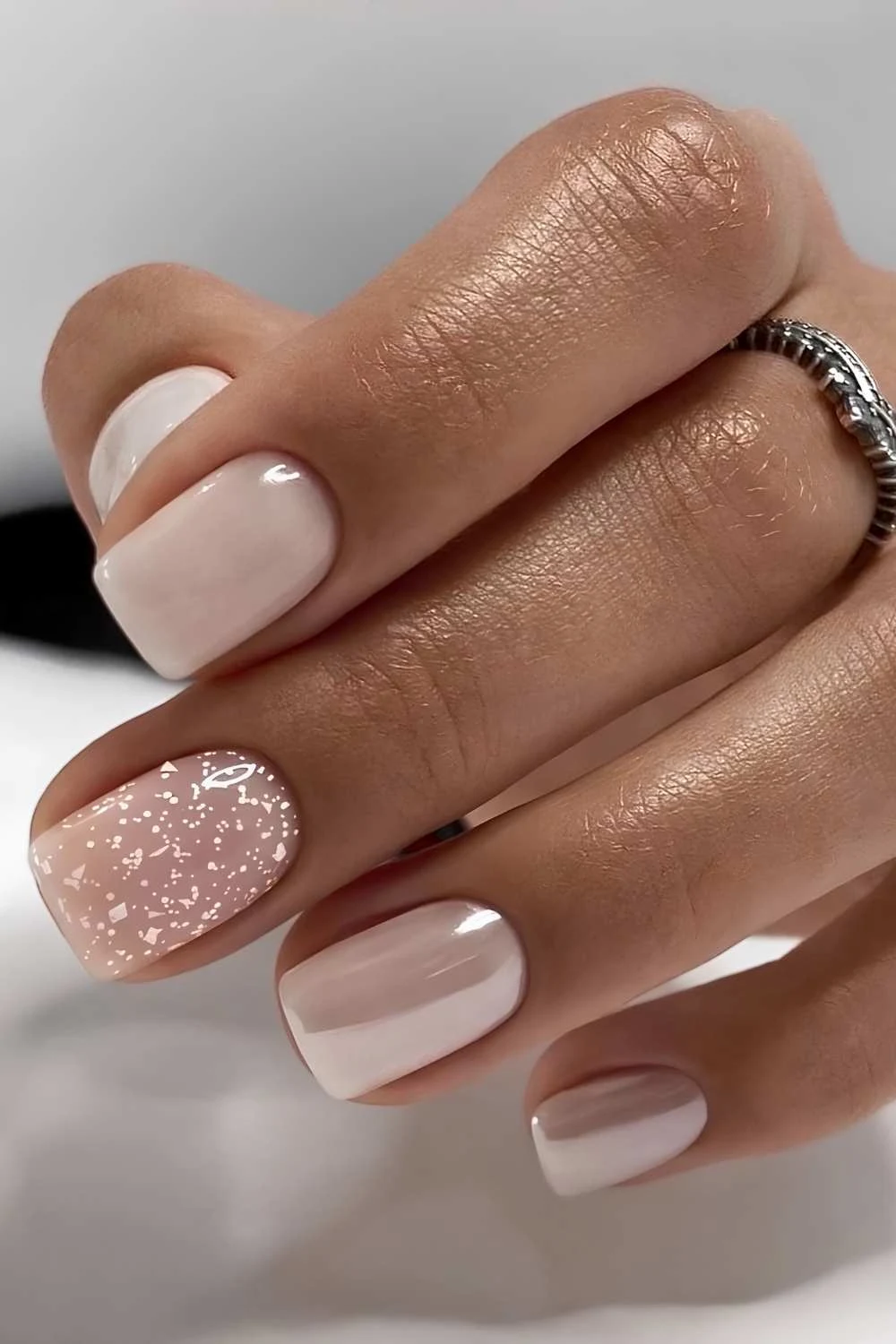 Neutral chrome nails with snow art