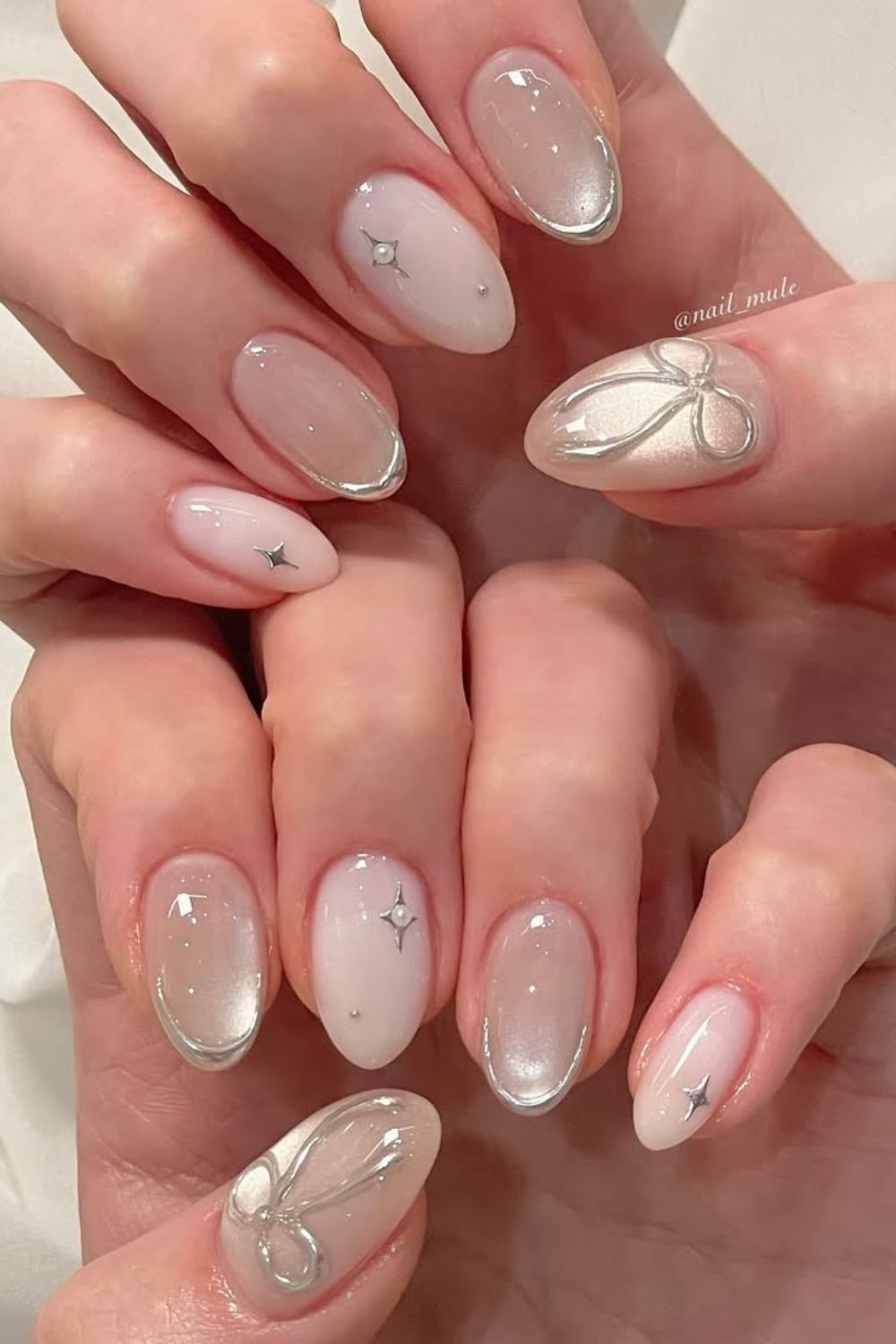 Neutral glass nails with silver bows and lines