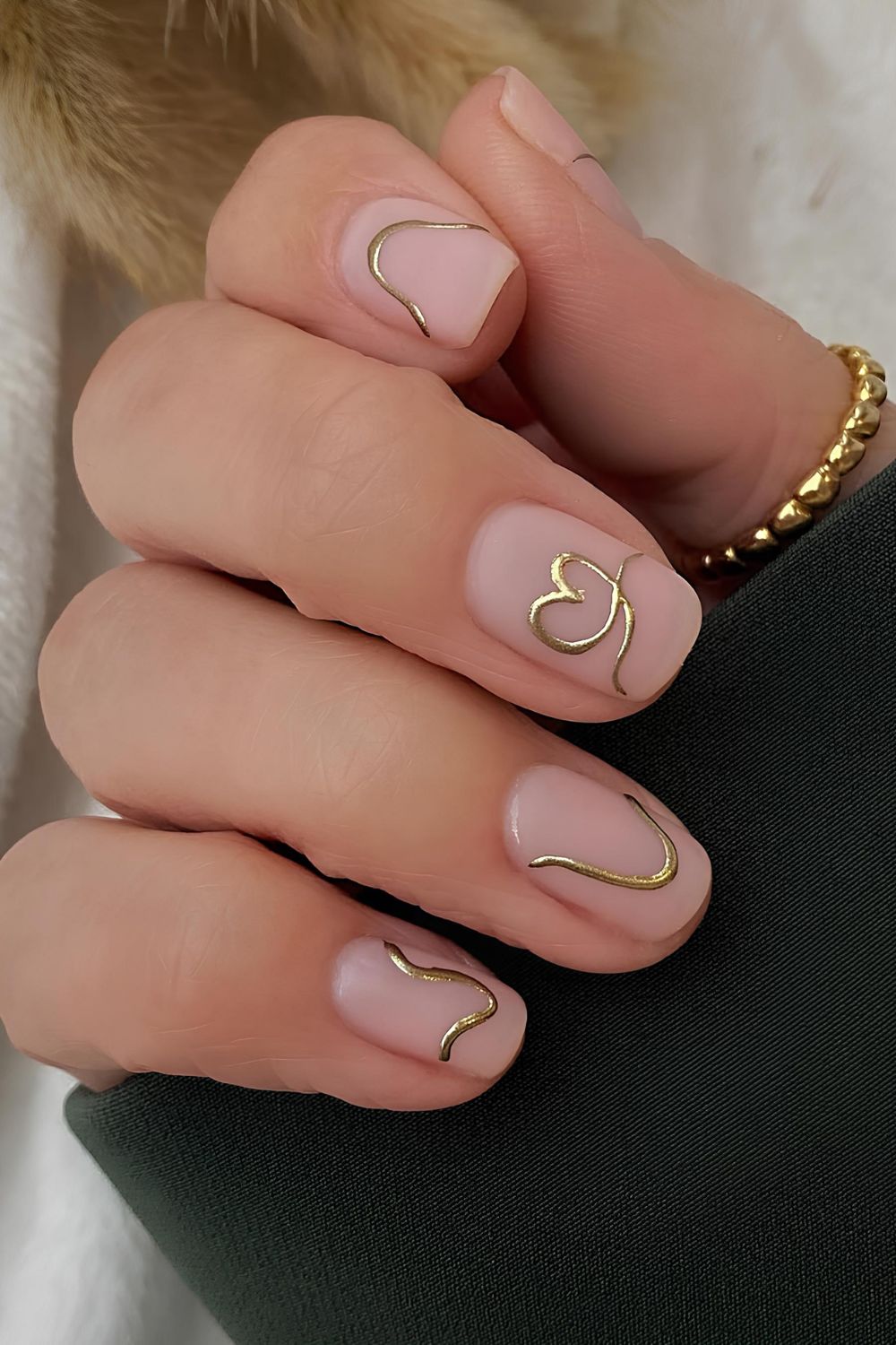 Neutral matte nails with gold chrome heart and line accents