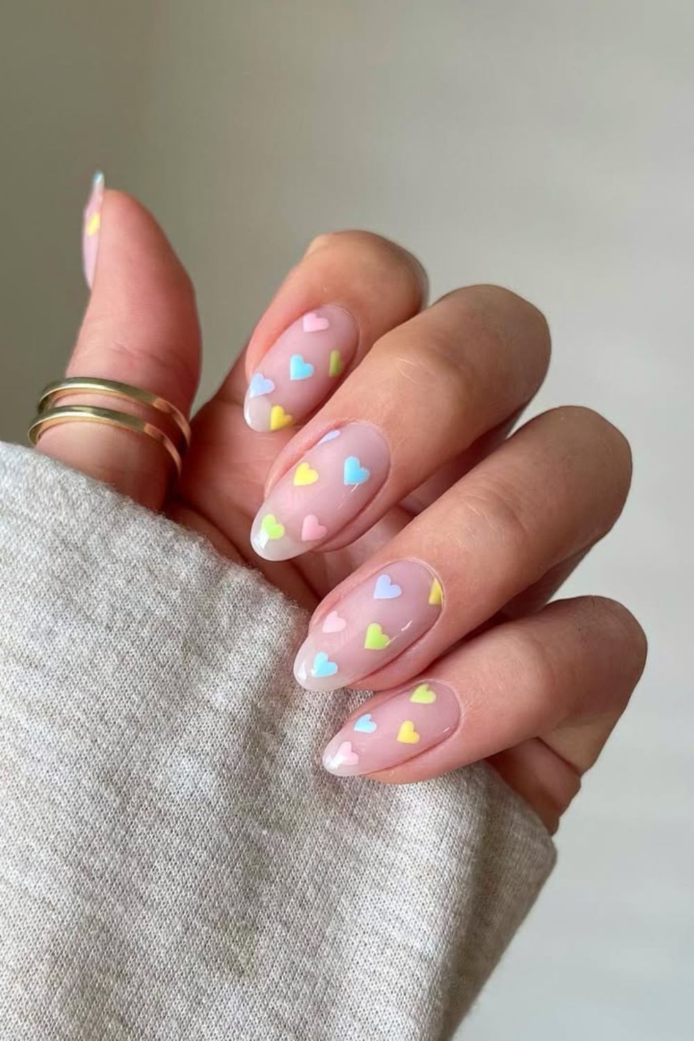 Neutral nails with colorful heart accents