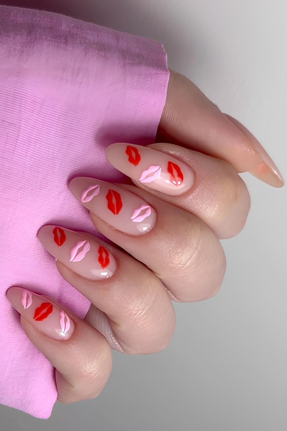 Neutral nails with pink and red kissy lips nail art