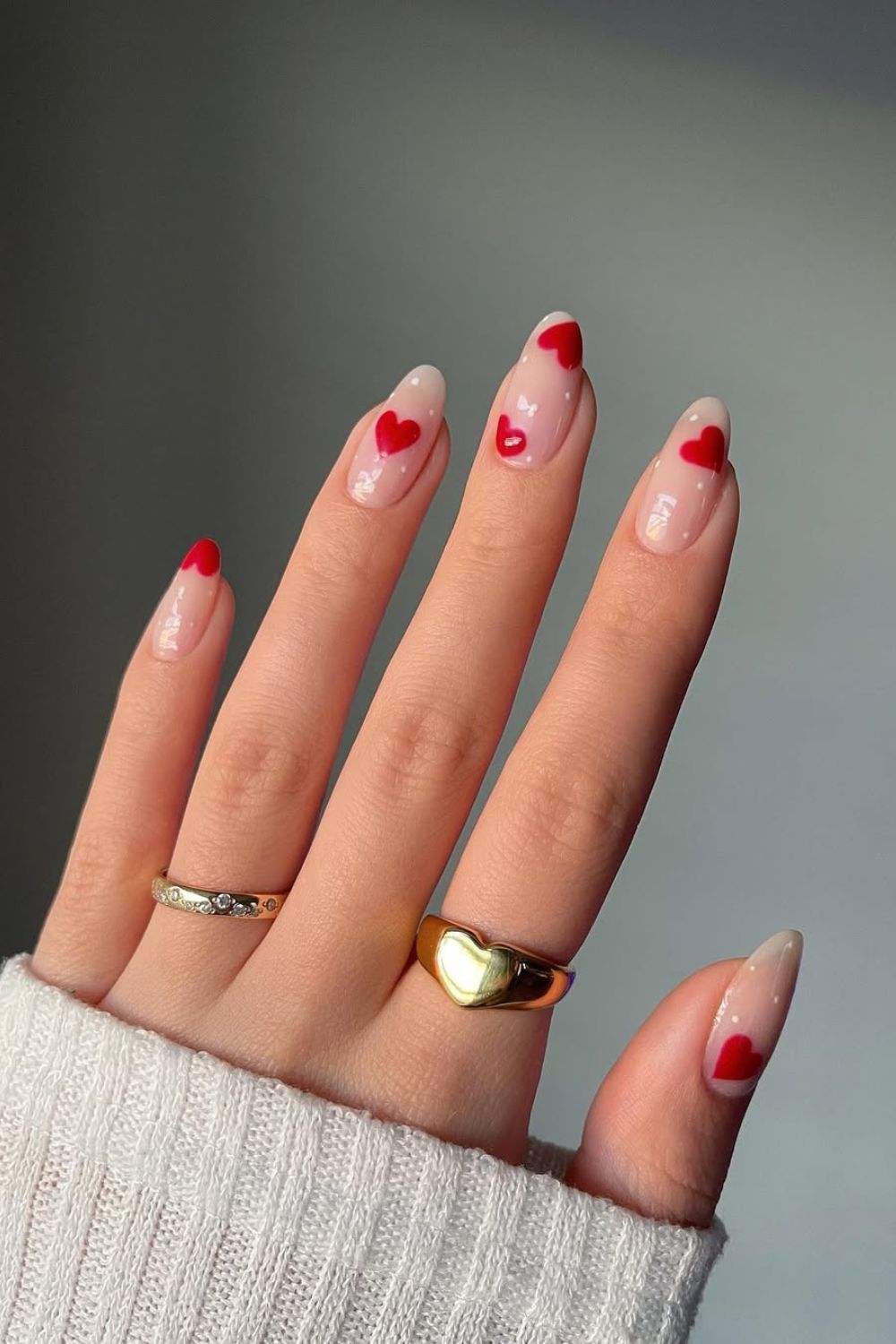 Neutral nails with red hearts and tiny white dots