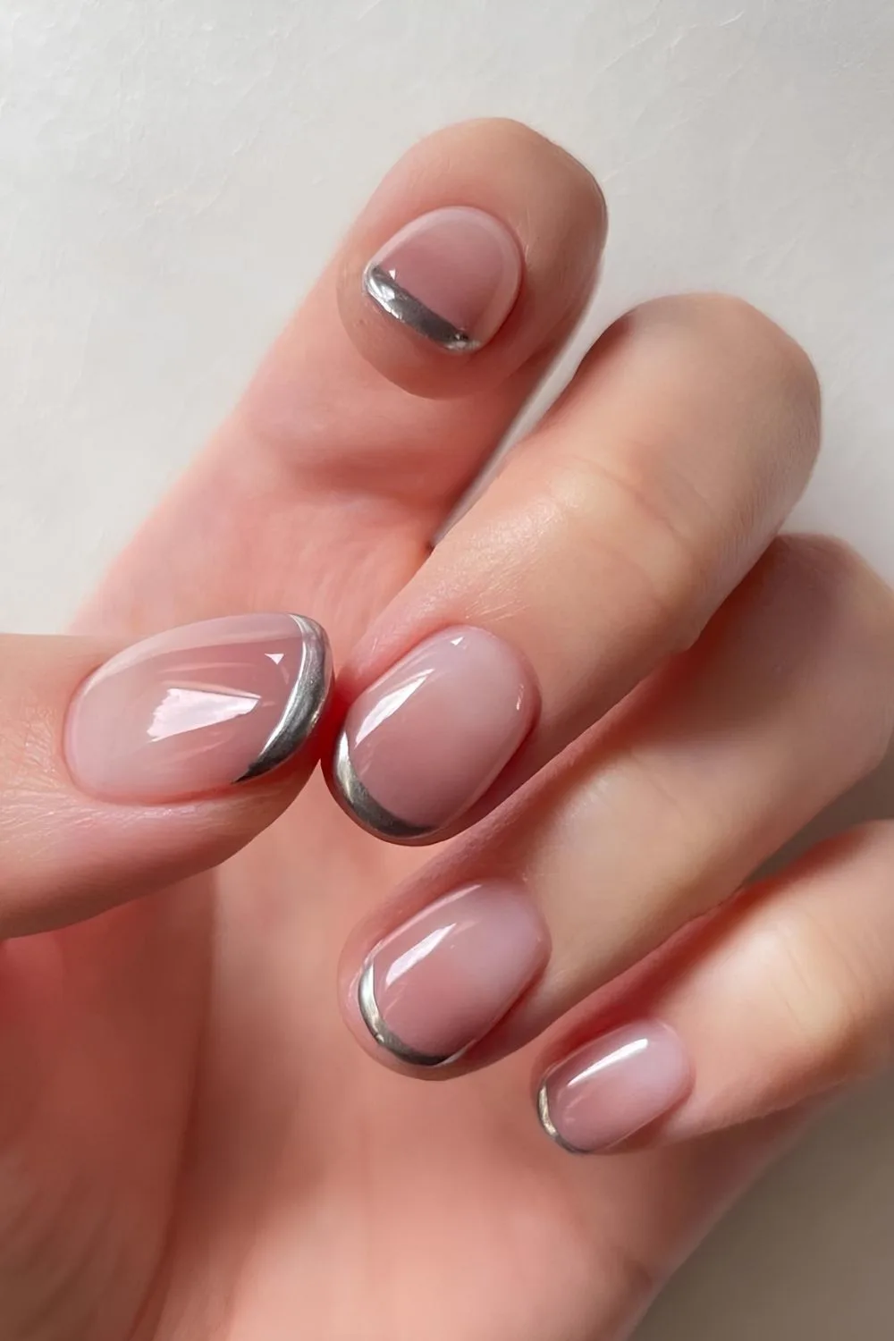 Neutral ombre nails with silver chrome tips