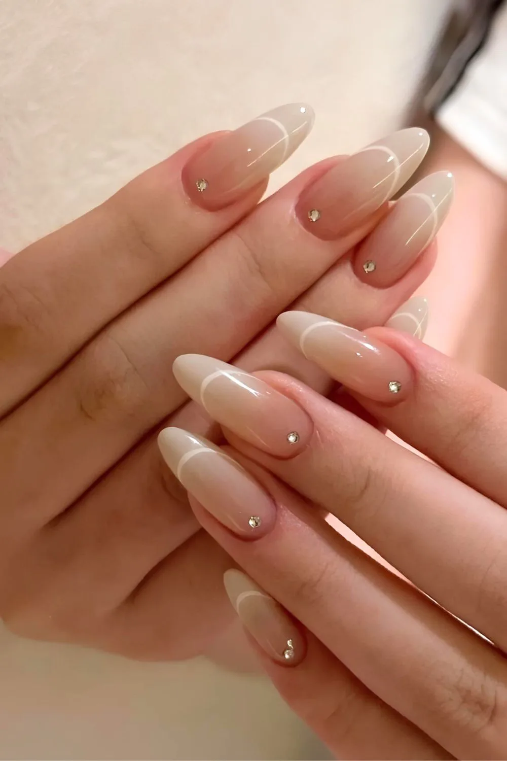 Neutral outlined ombre nails with rhinestone accents