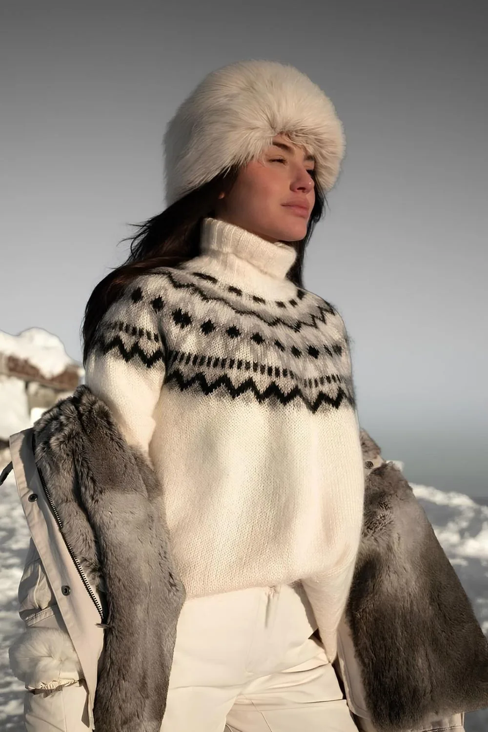 Nordic knit sweater and fur hat paired with jacket and white trousers