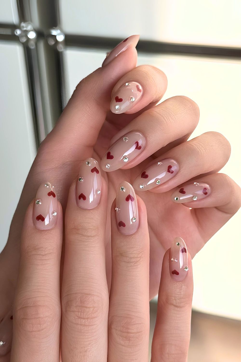 Nude mani with gems and red hearts