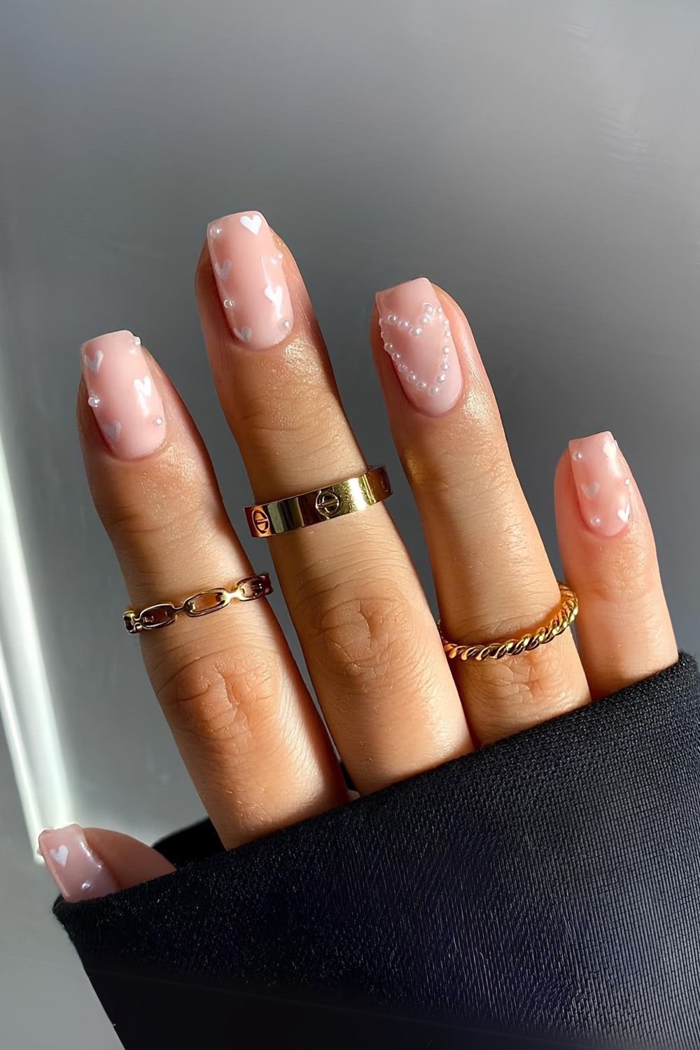 Nude manicure with pearls and hearts