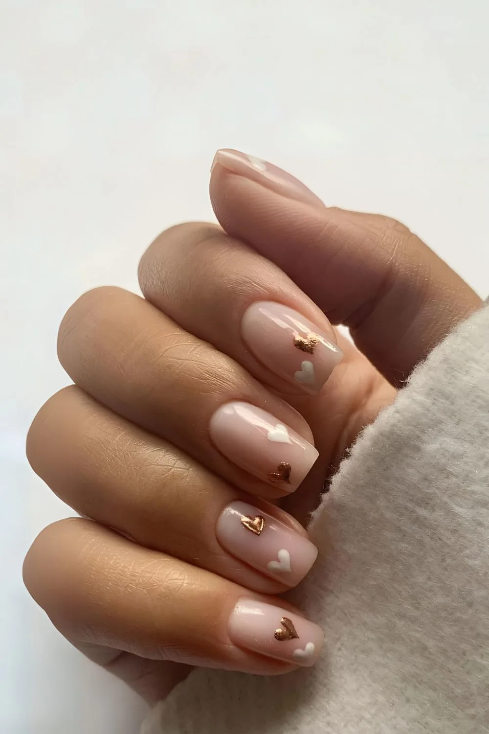 Nude nails with gold and white hearts