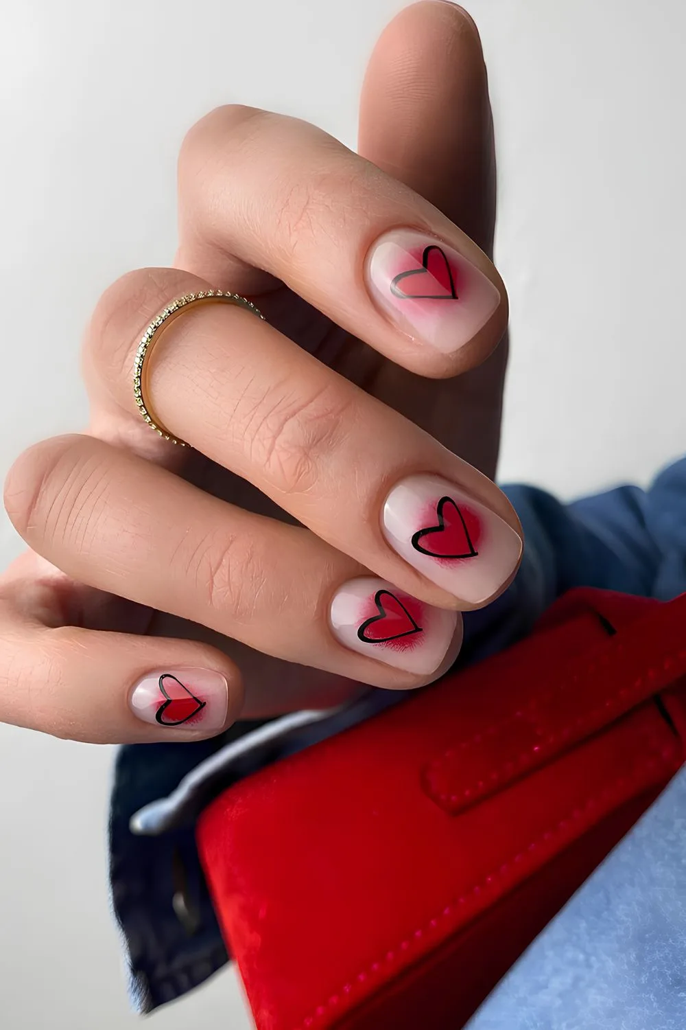 Nude nails with red aura and black hearts