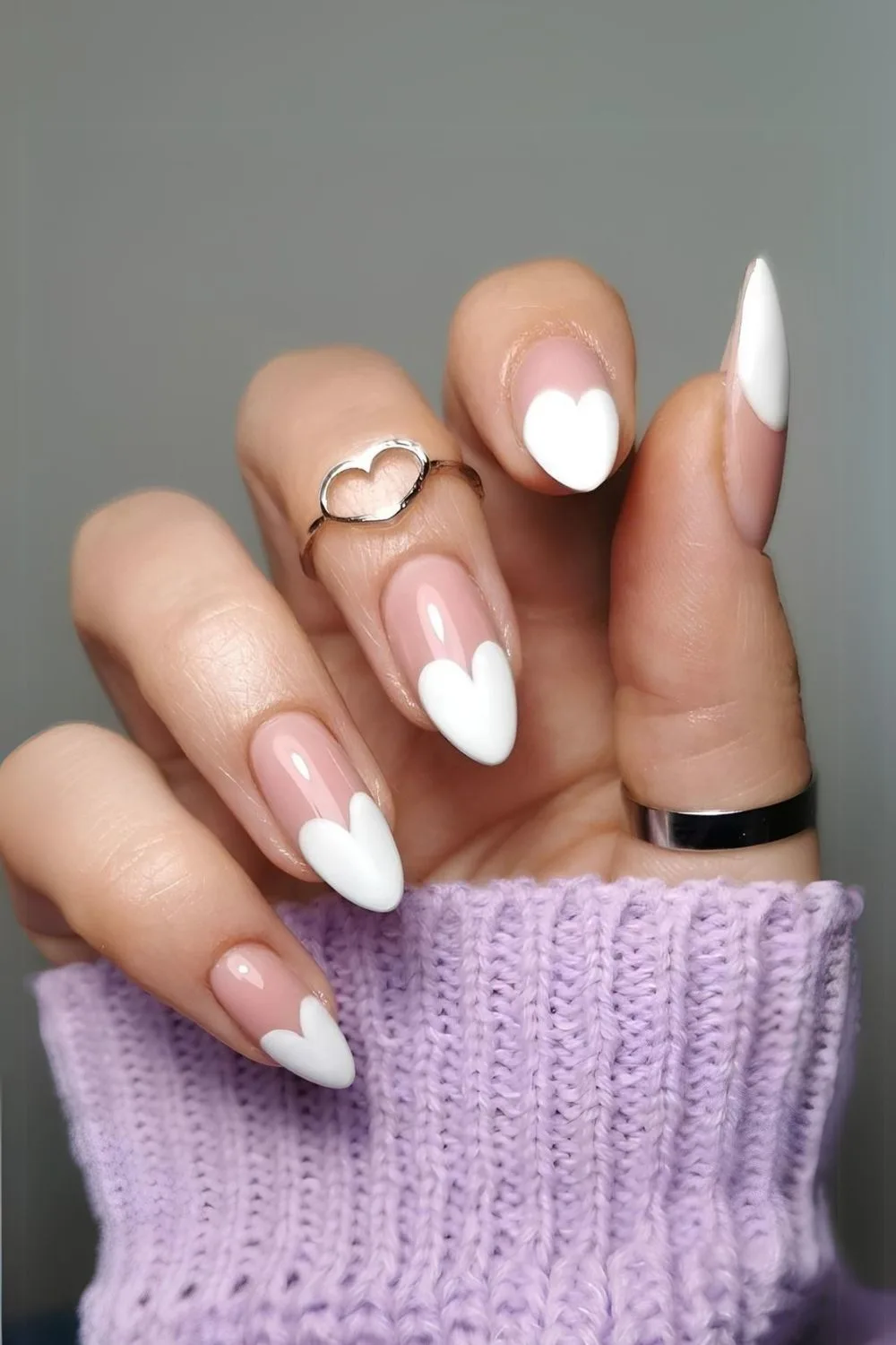 Nude nails with white heart-shaped French tips