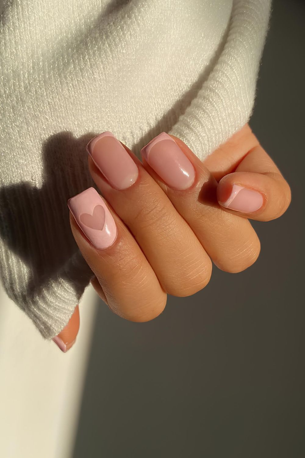 Pastel pink nails with negative space heart accent