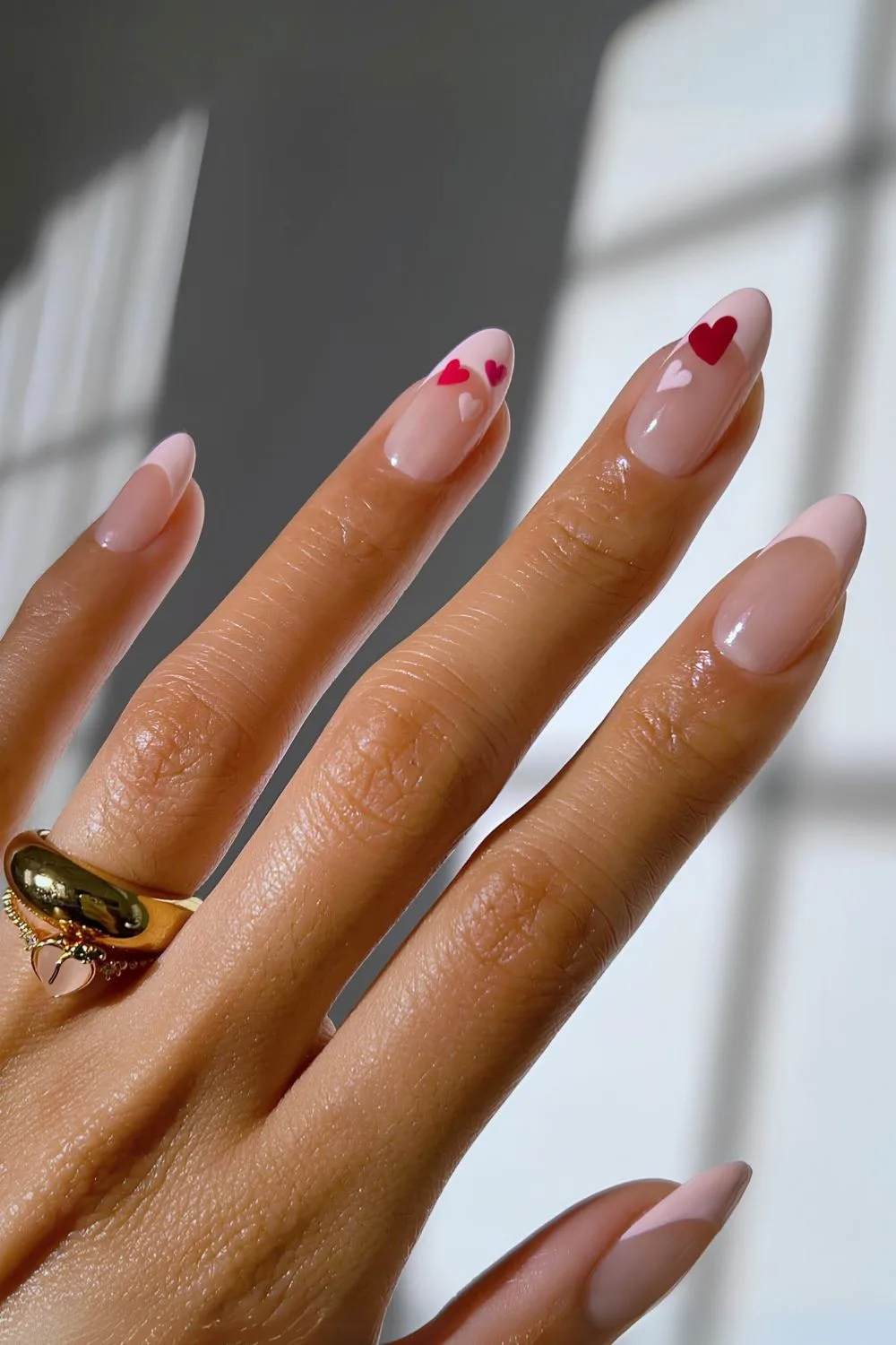 Pink French manicure with heart accents