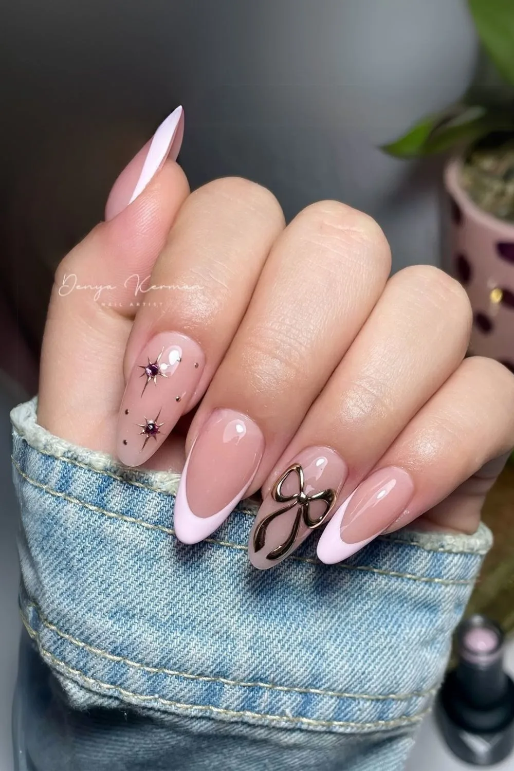 Pink French nails with chrome stars and bows