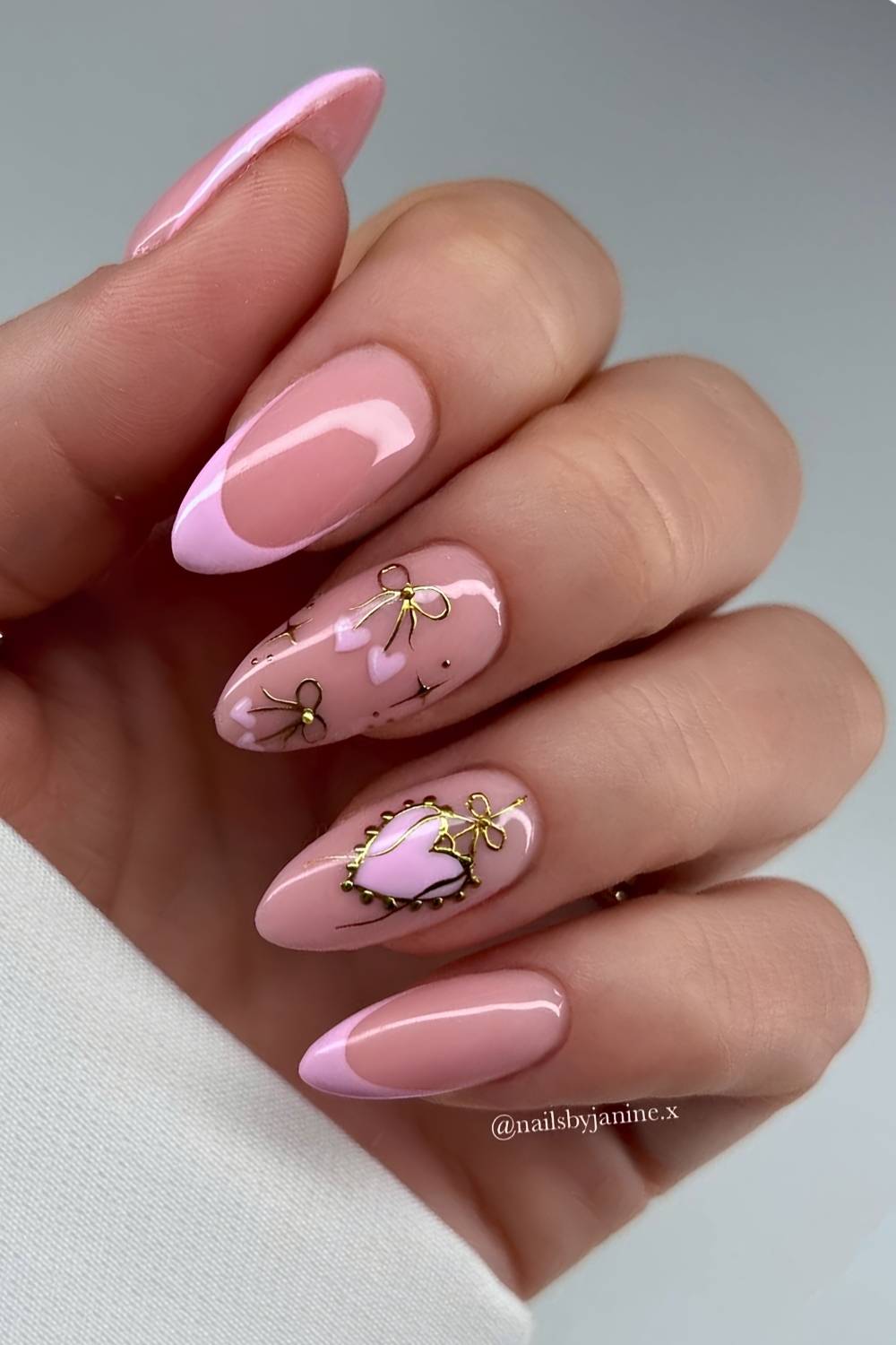 Pink French nails with hearts and gold details