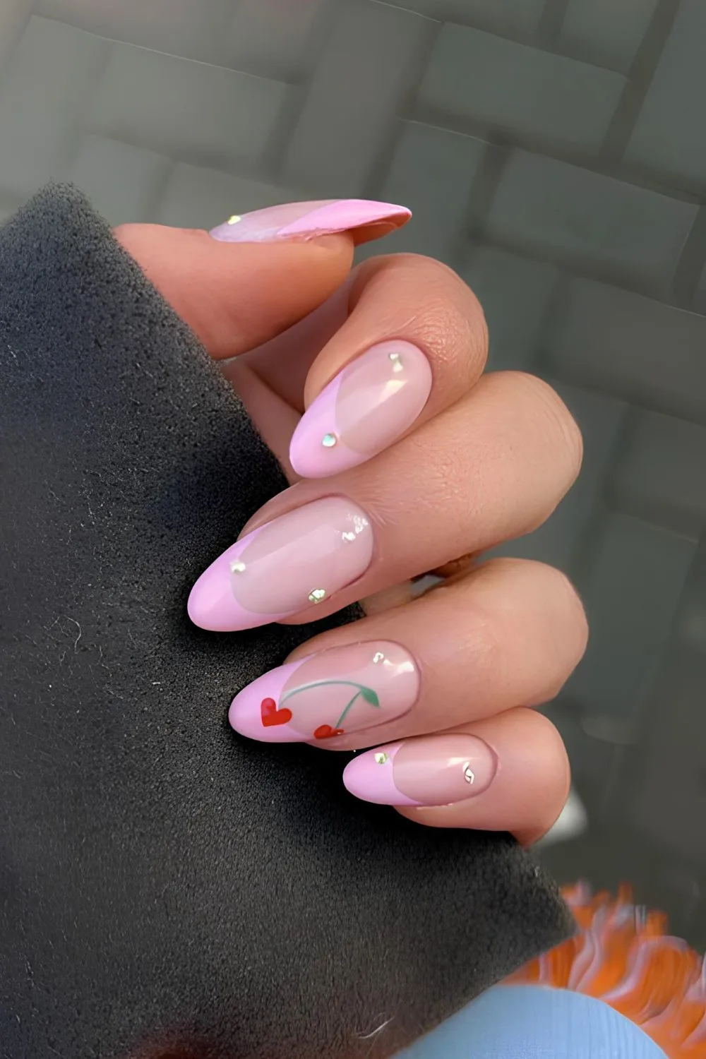 Pink French nails with studs and cherry art